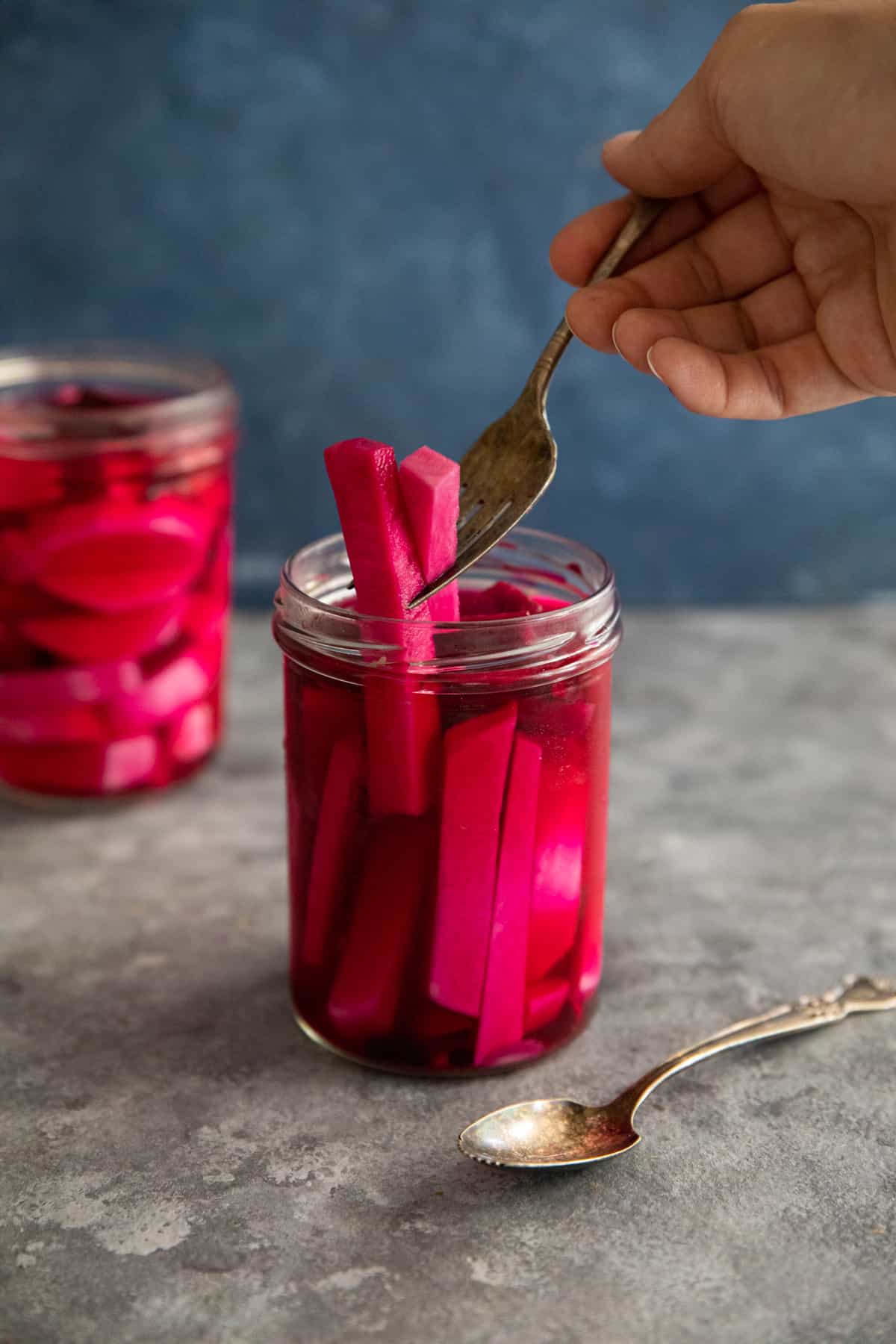 pink turnips picked up with a fork. 