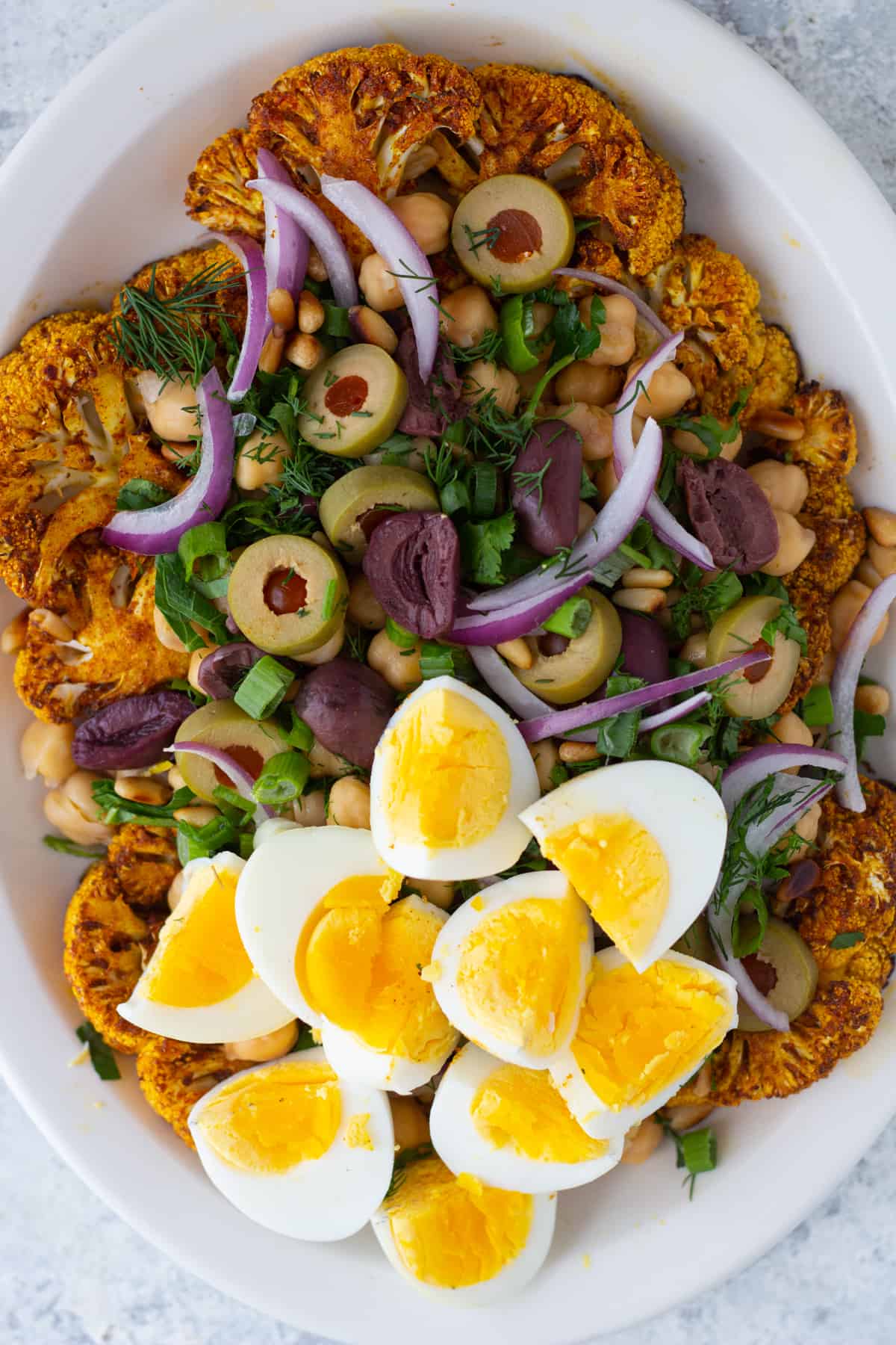 Roasted cauliflower salad with Mediterranean spices is so flavorful and easy to make. The cauliflower is seasoned with warm spices and roasted to perfection, then topped with a zesty yogurt dressing, making every bite extra delicious.
