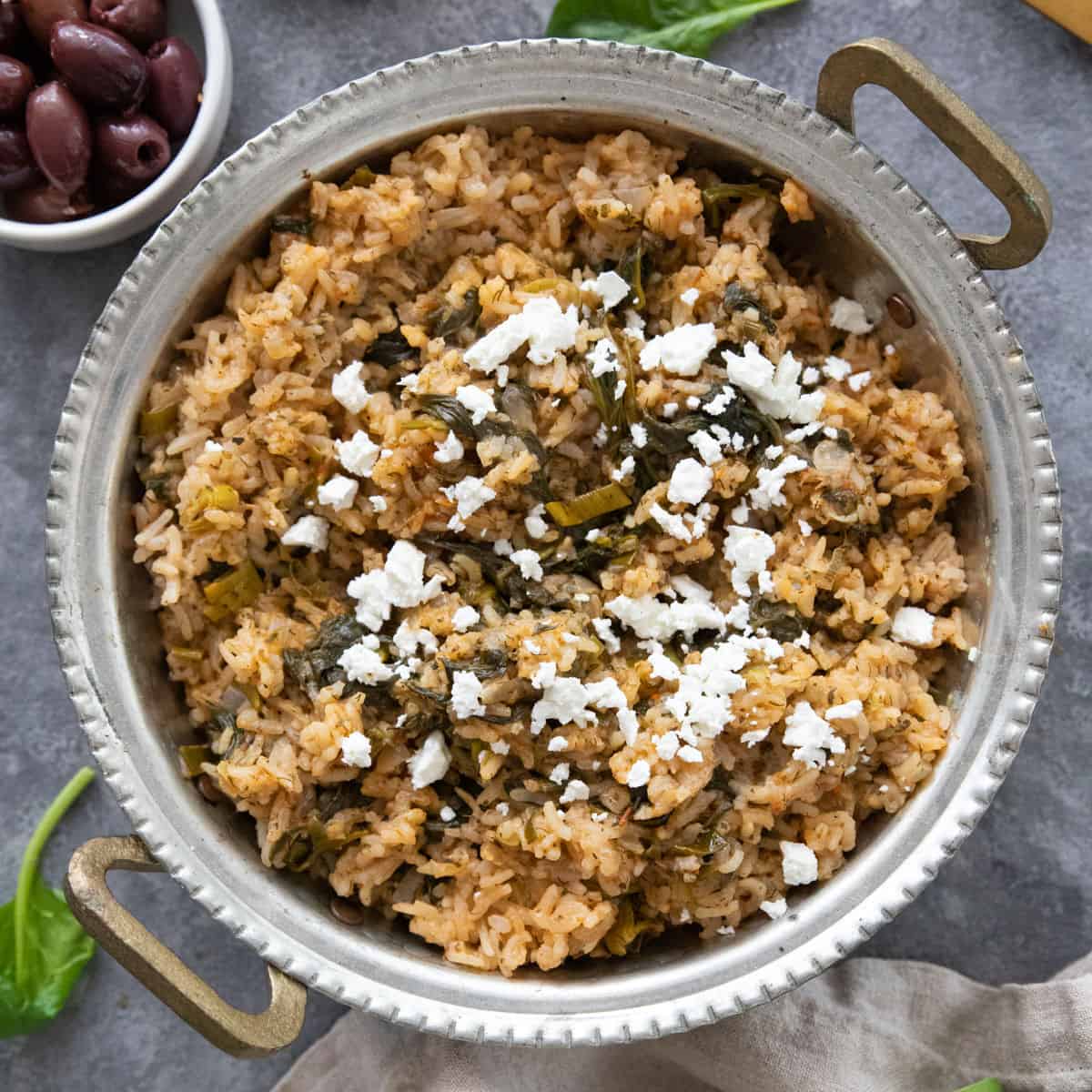 Spanakorizo is a classic Greek spinach rice that's easy and comforting. You only need a few ingredients to make this delicious vegetarian recipe.

