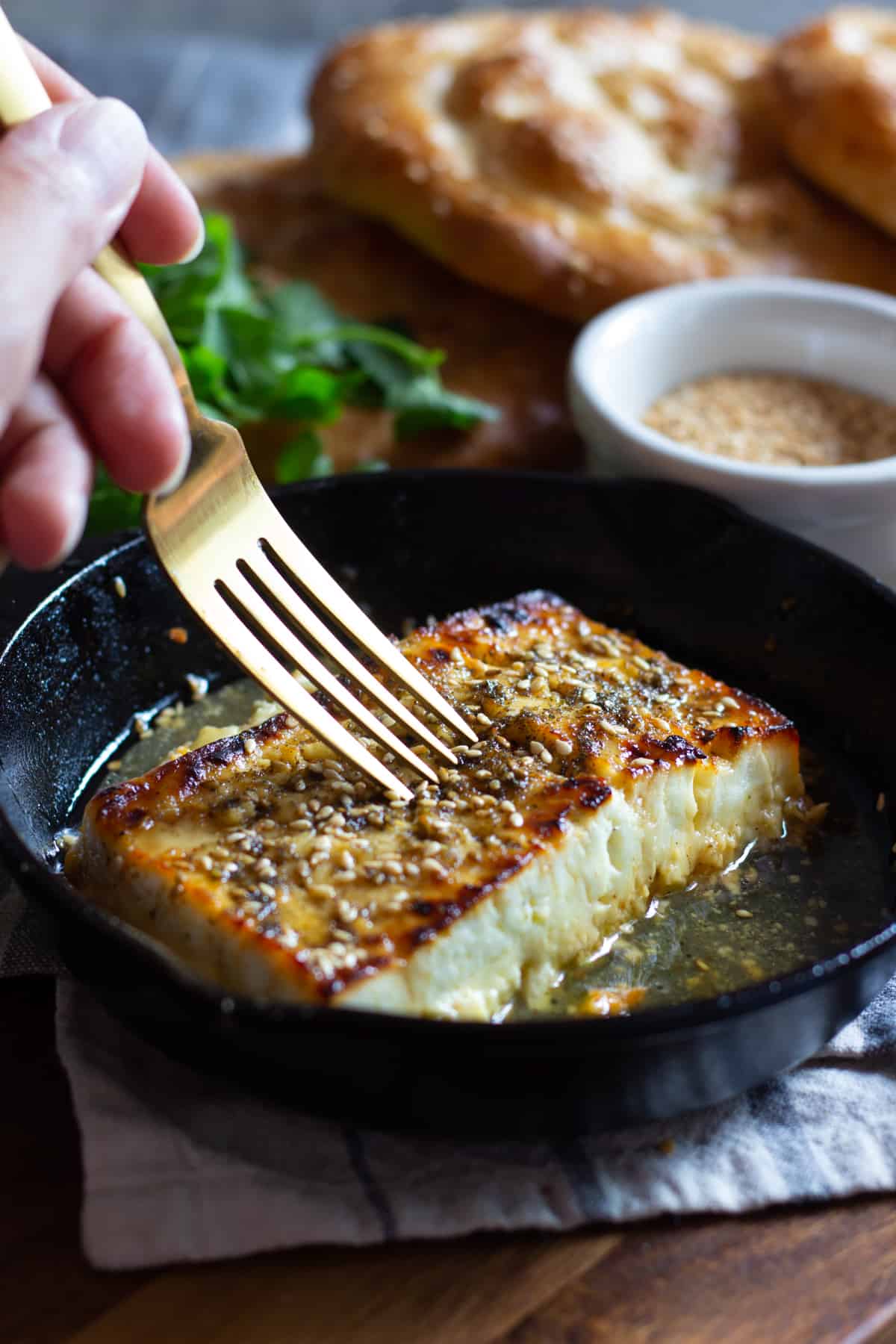 This baked feta recipe is easy and makes a delicious appetizer. It's made with only five ingredients and is topped with honey and zaatar. 
