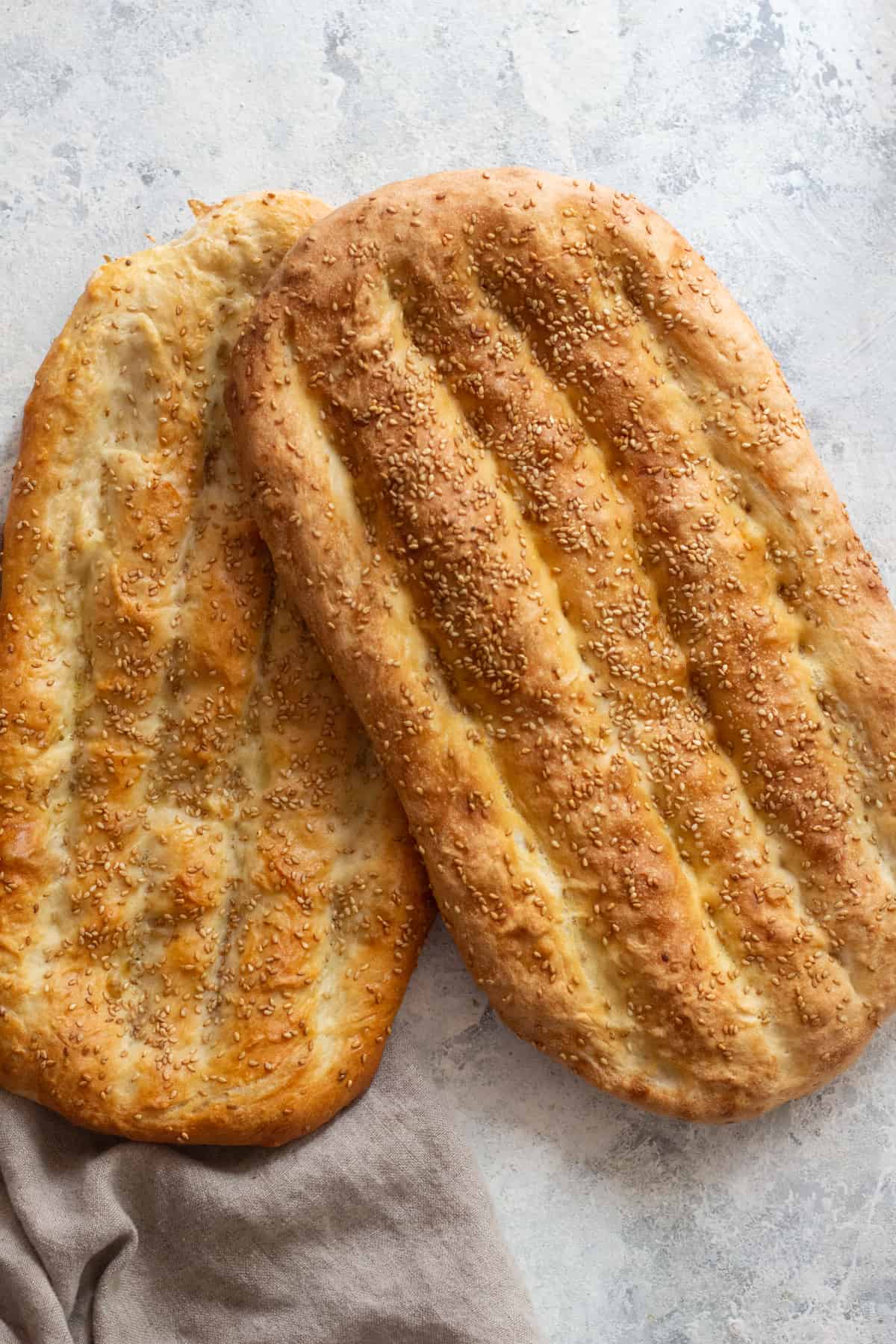 two loaves of Persian flatbread cooked in the oven. 