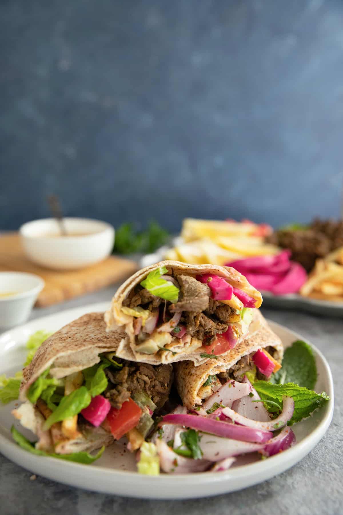 close up shot of beef shawarma wrapped in pita. 