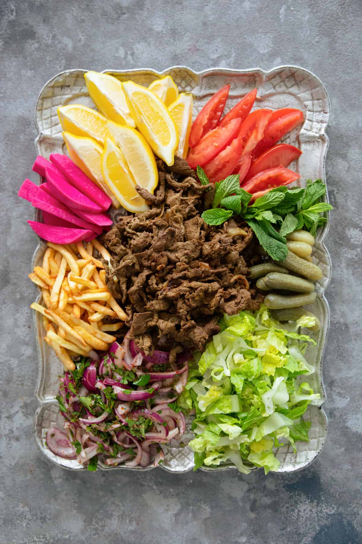overhead shot of beef shawarma with fixings on a backdrop. 