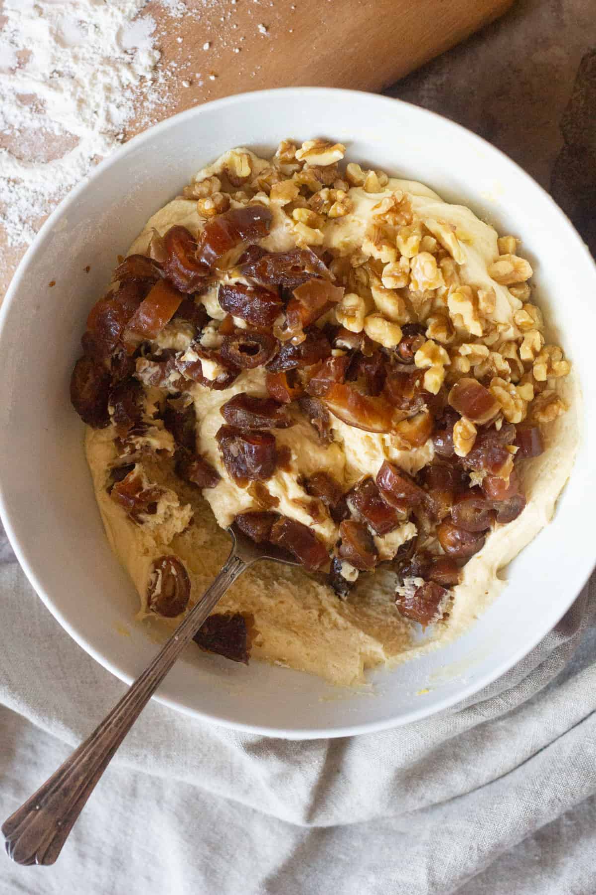 To make date cake mix all the ingredients according to the recipe and fold in chopped dates and walnuts.