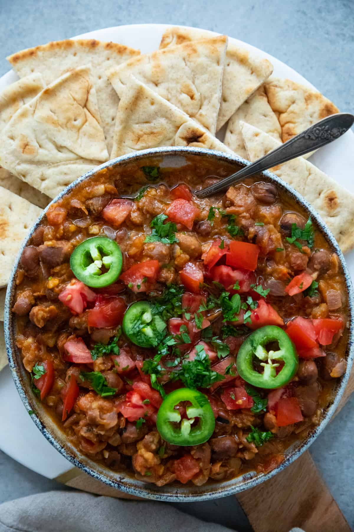Ful medames in a bowl with pita. 