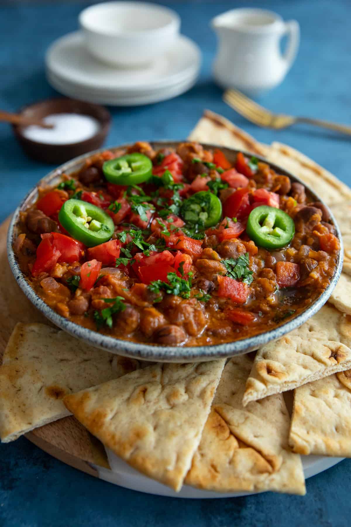 a bowl of ful on a plate. 