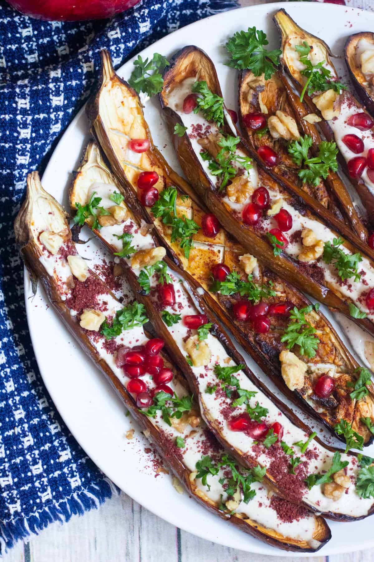 Slices of eggplant roasted and topped with yogurt tahini sauce. 