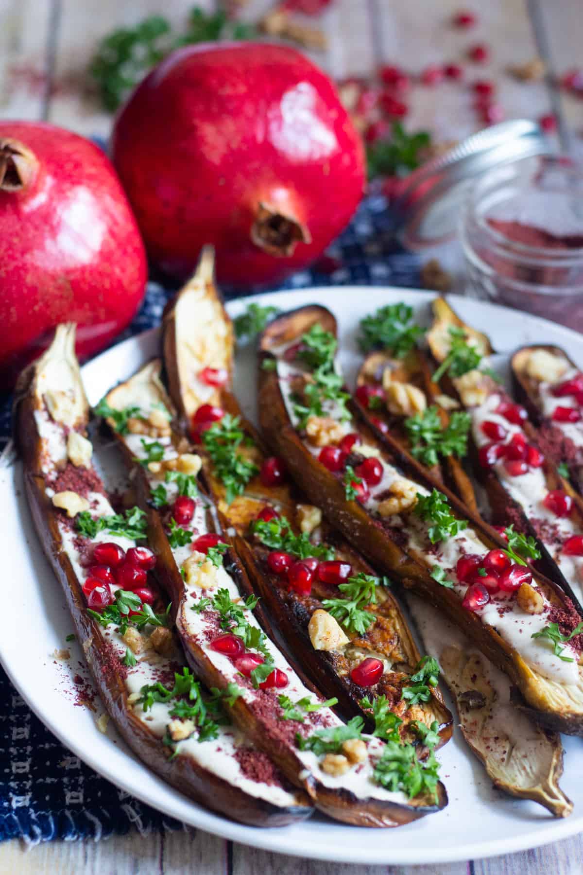 Oven Roasted Middle Eastern Eggplant with sumac, yogurt tahini sauce, pomegranates and walnuts.