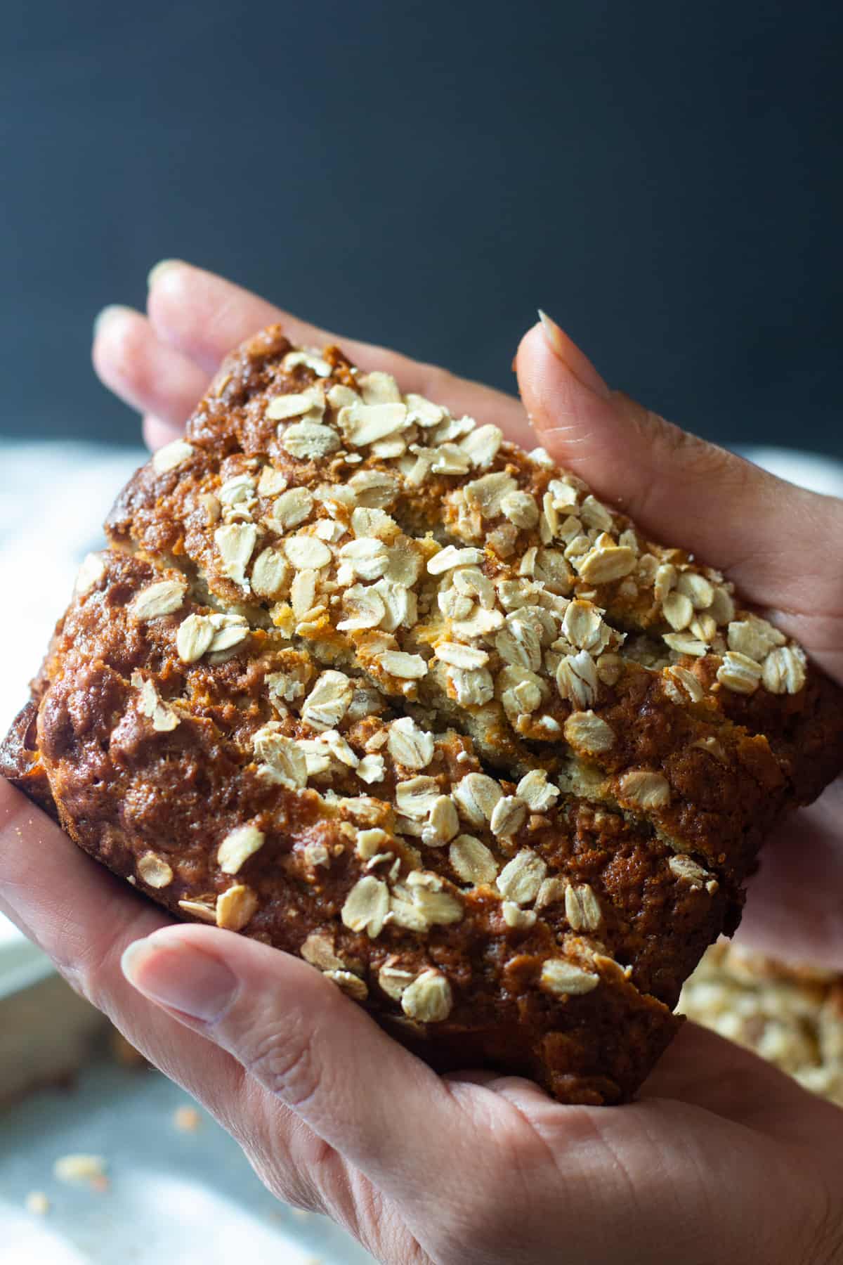 Slices of oatmeal banana bread stacked on each other. 