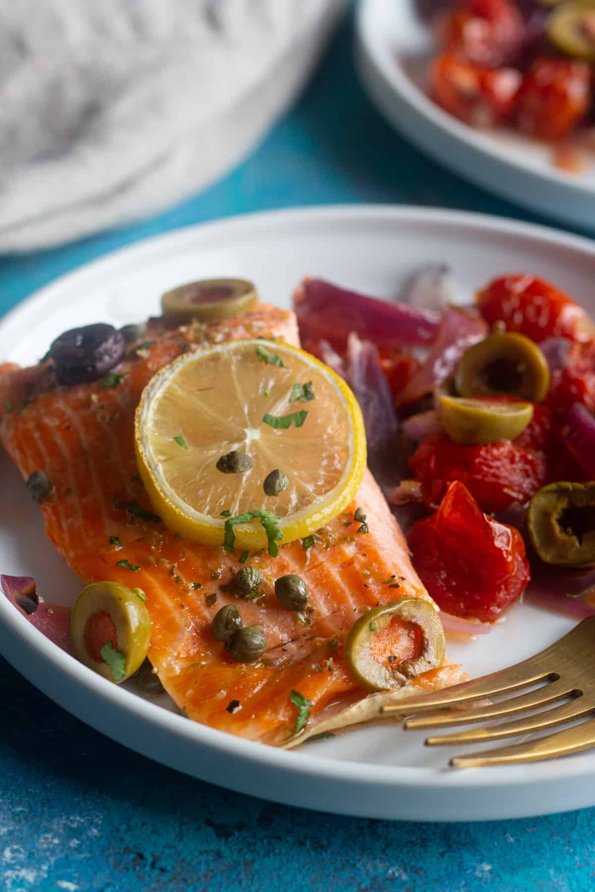 oven baked salmon with lemon, capers and olives. 