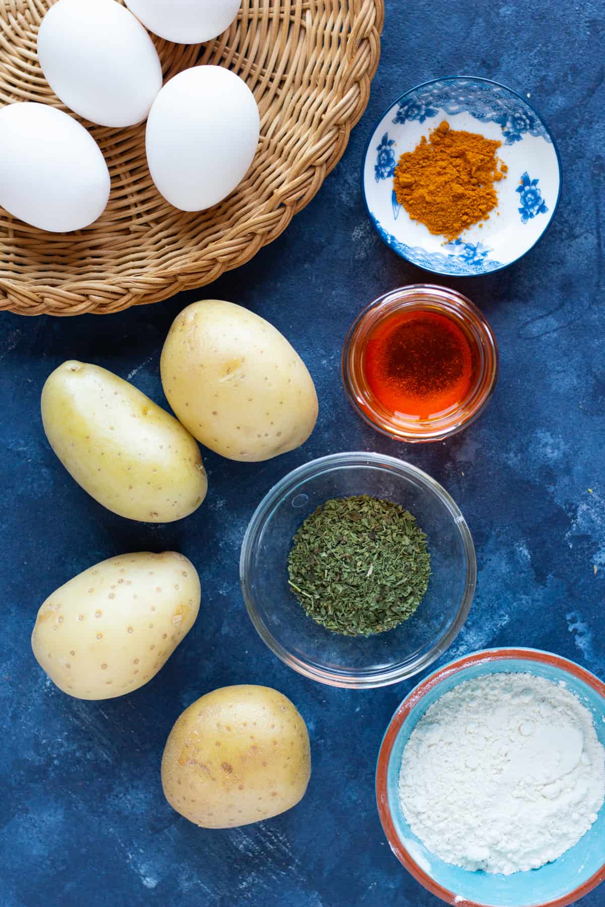 ingredient shot with potatoes, eggs, turmeric, saffron, flour and mint