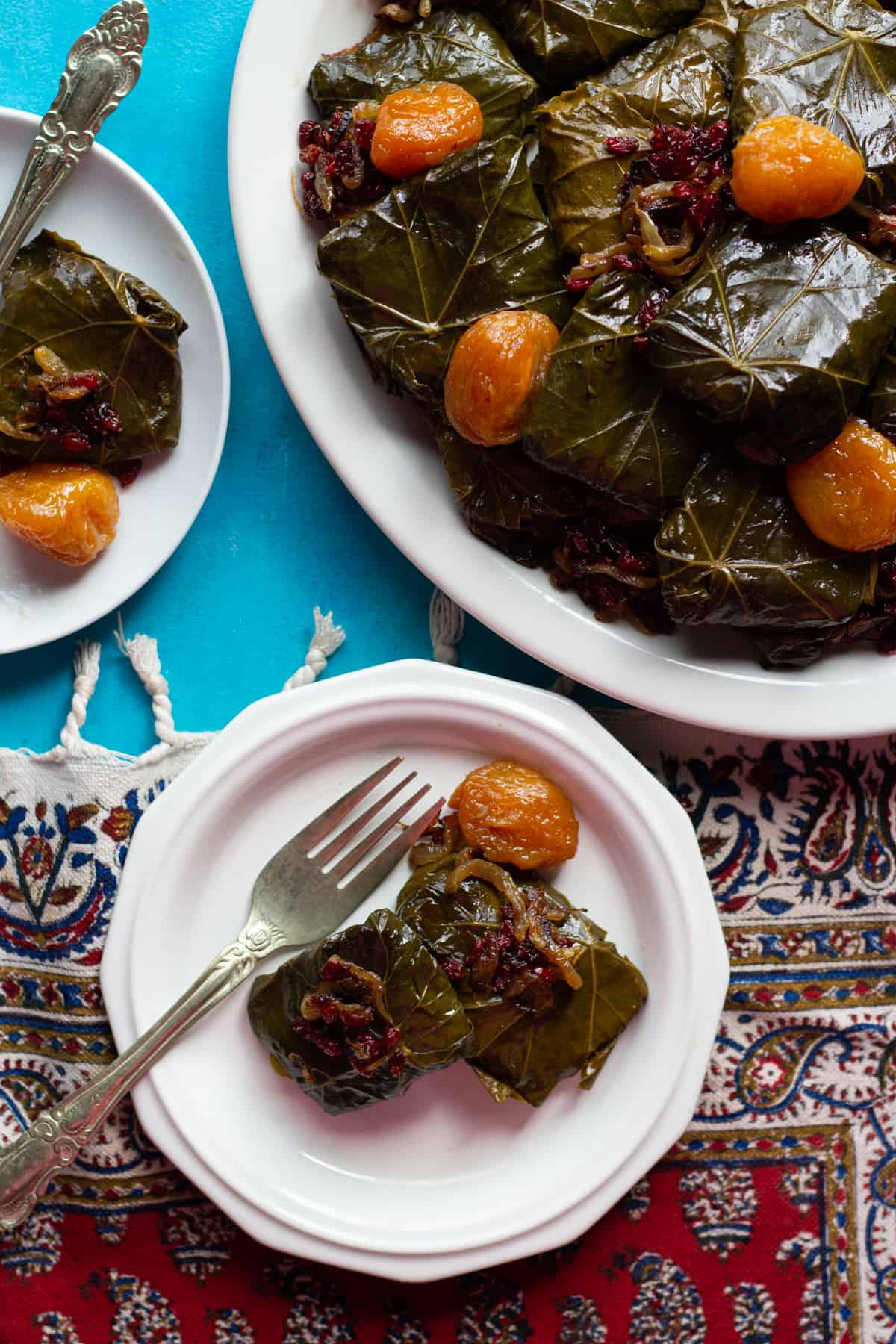 stuffed grape leaves made Persian style served on three plates. 