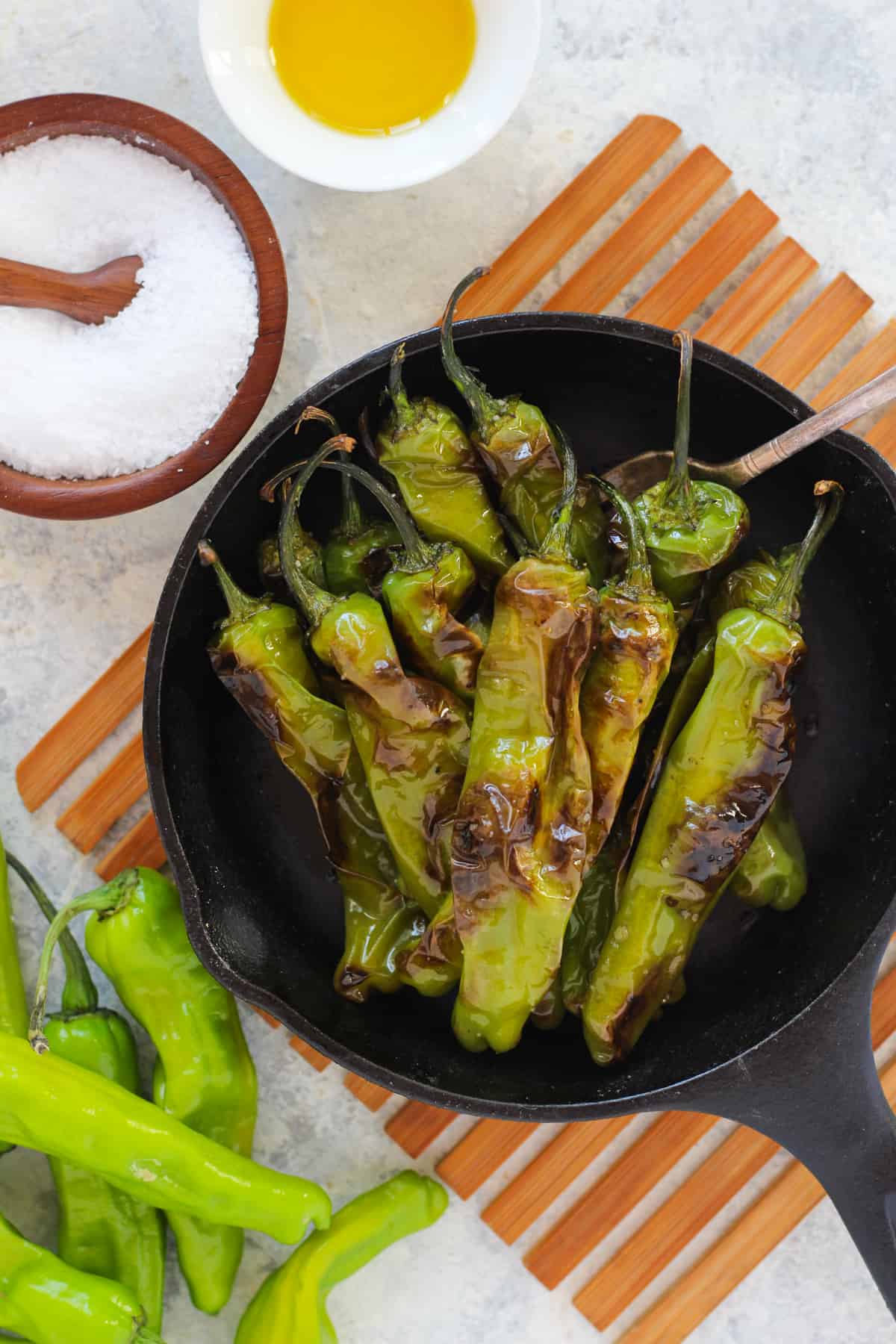 This easy blistered shishito peppers recipe is so easy to make. These little mild peppers are perfect to snack on as an appetizer. Make sure your skillet is hot to have the perfect char on each pepper. 
