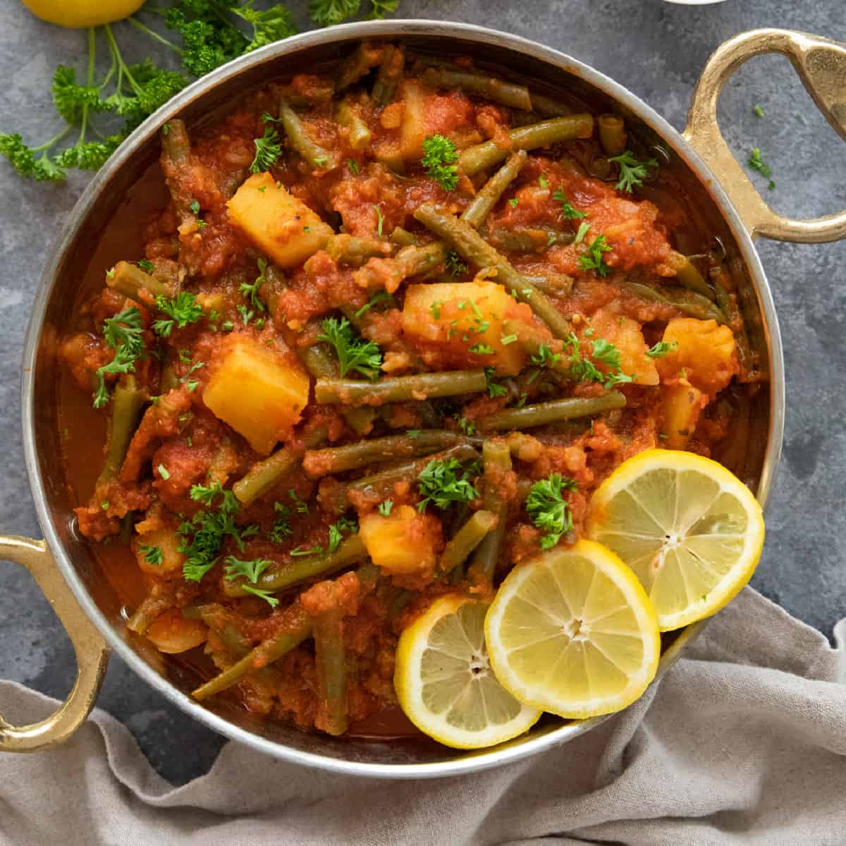 A pan of Greek green beans fasolakia which is a vegetarian dinner recipe.