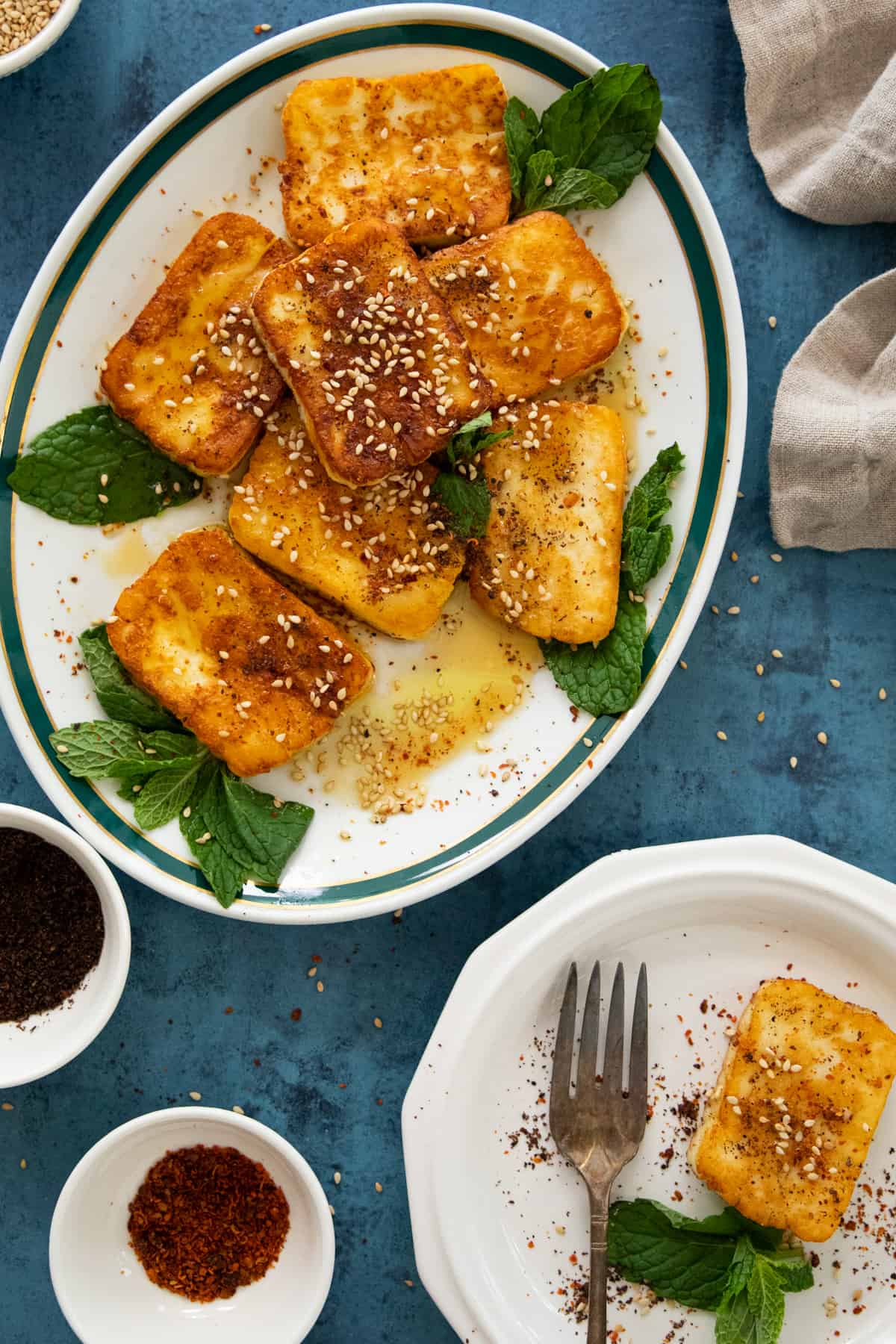 halloumi fries on two plates with spices. 