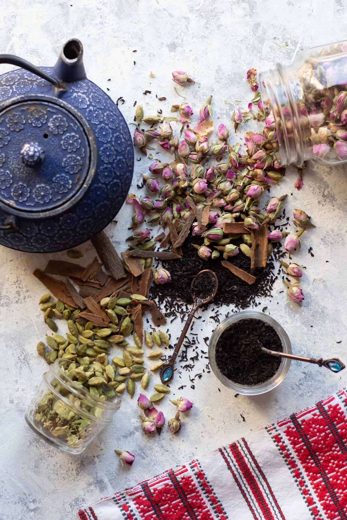 Cardamom, rose, tea and cinnamon spread on a white background. 