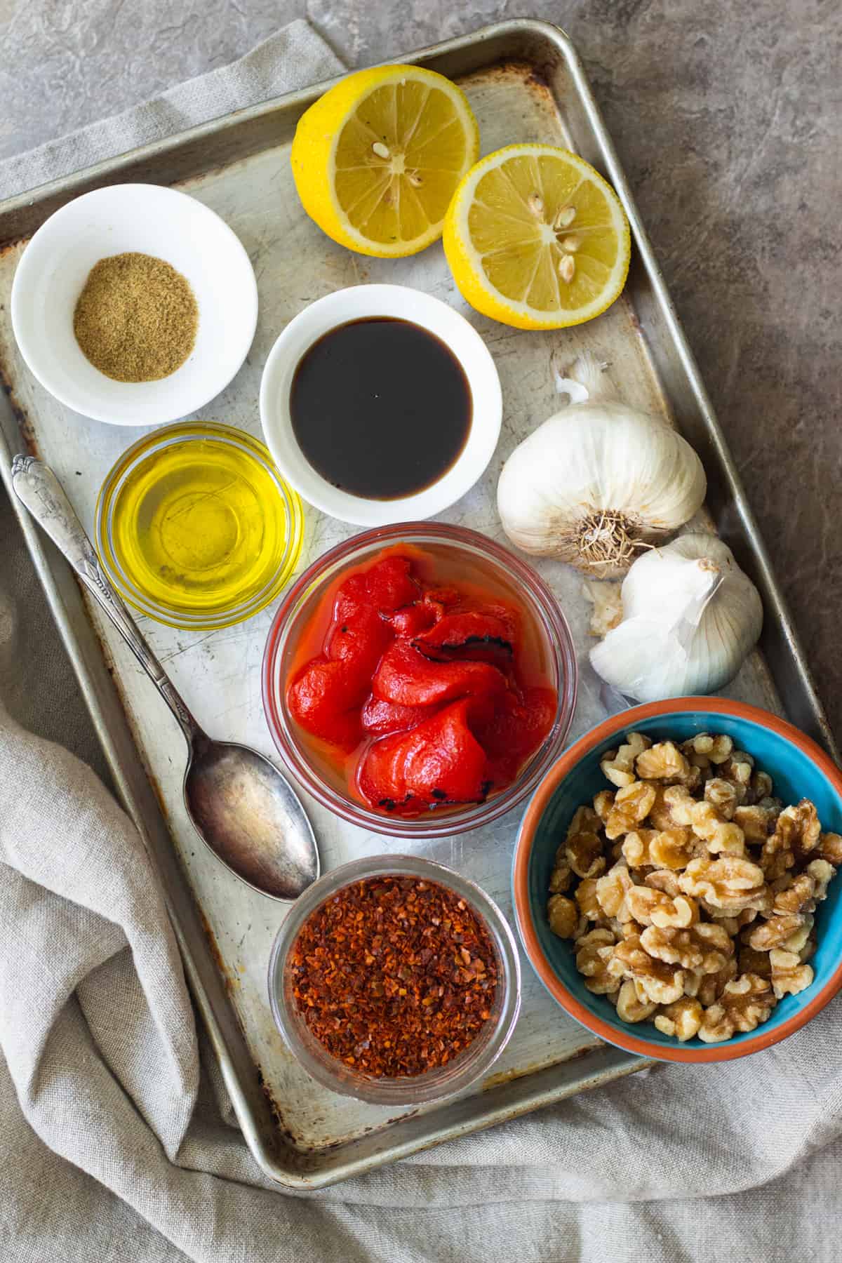 Muhammara ingredients are roasted red pepper, lemon, walnuts, pomegranate molasses, Aleppo pepper, olive oil and cumin and garlic
