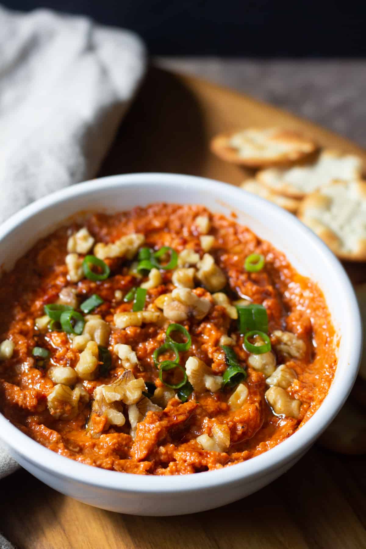 Roasted red pepper dip topped with walnuts and green onion