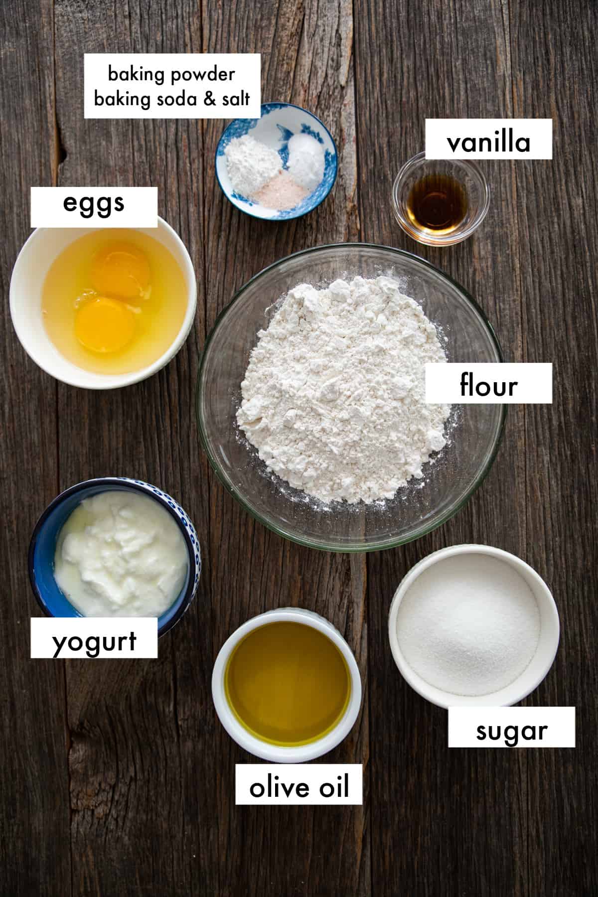 ingredients are olive oil, yogurt, eggs, sugar, vanilla, baking powder, baking soda and salt.