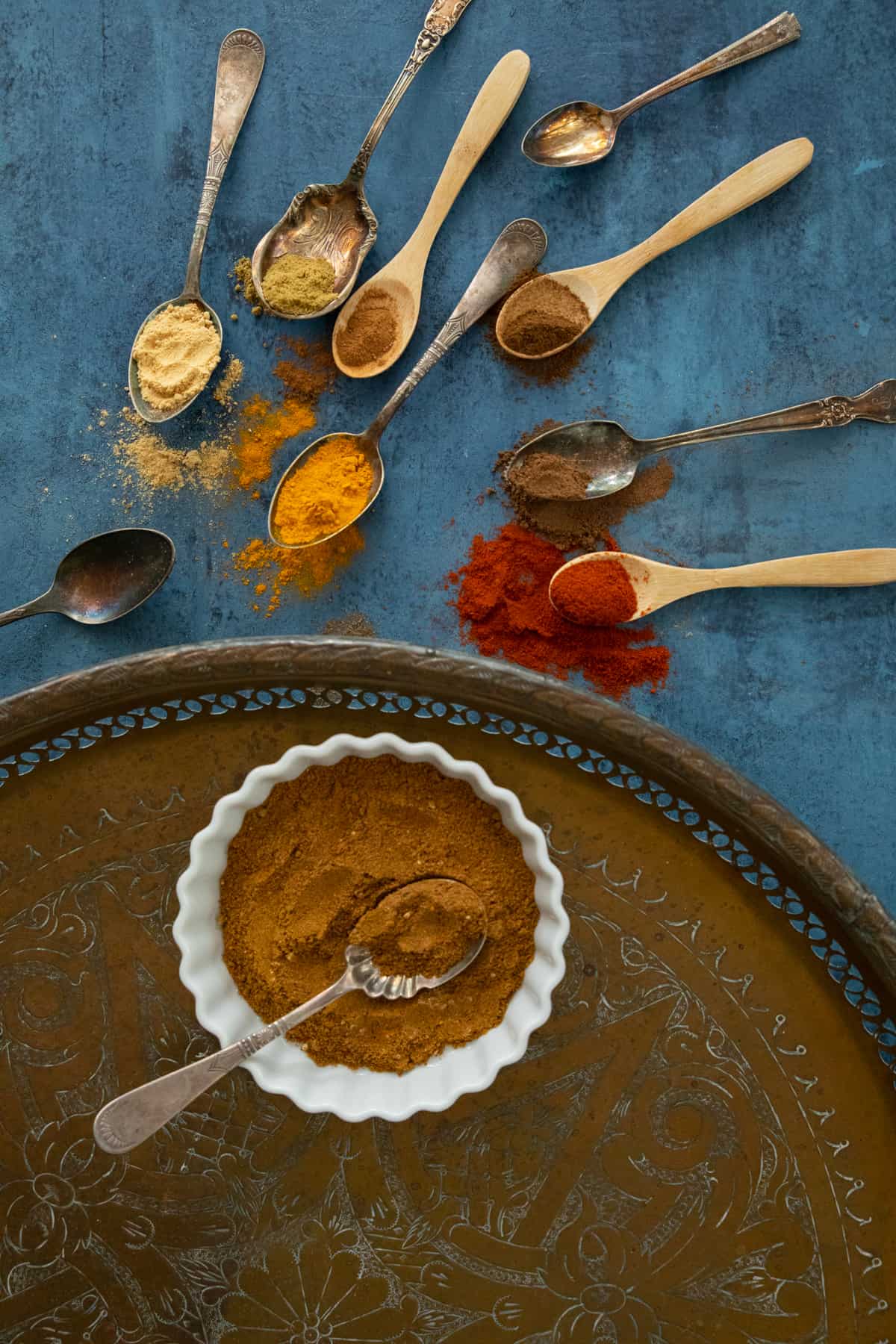 ras el hanout on a tray placed on a blue backdrop. 