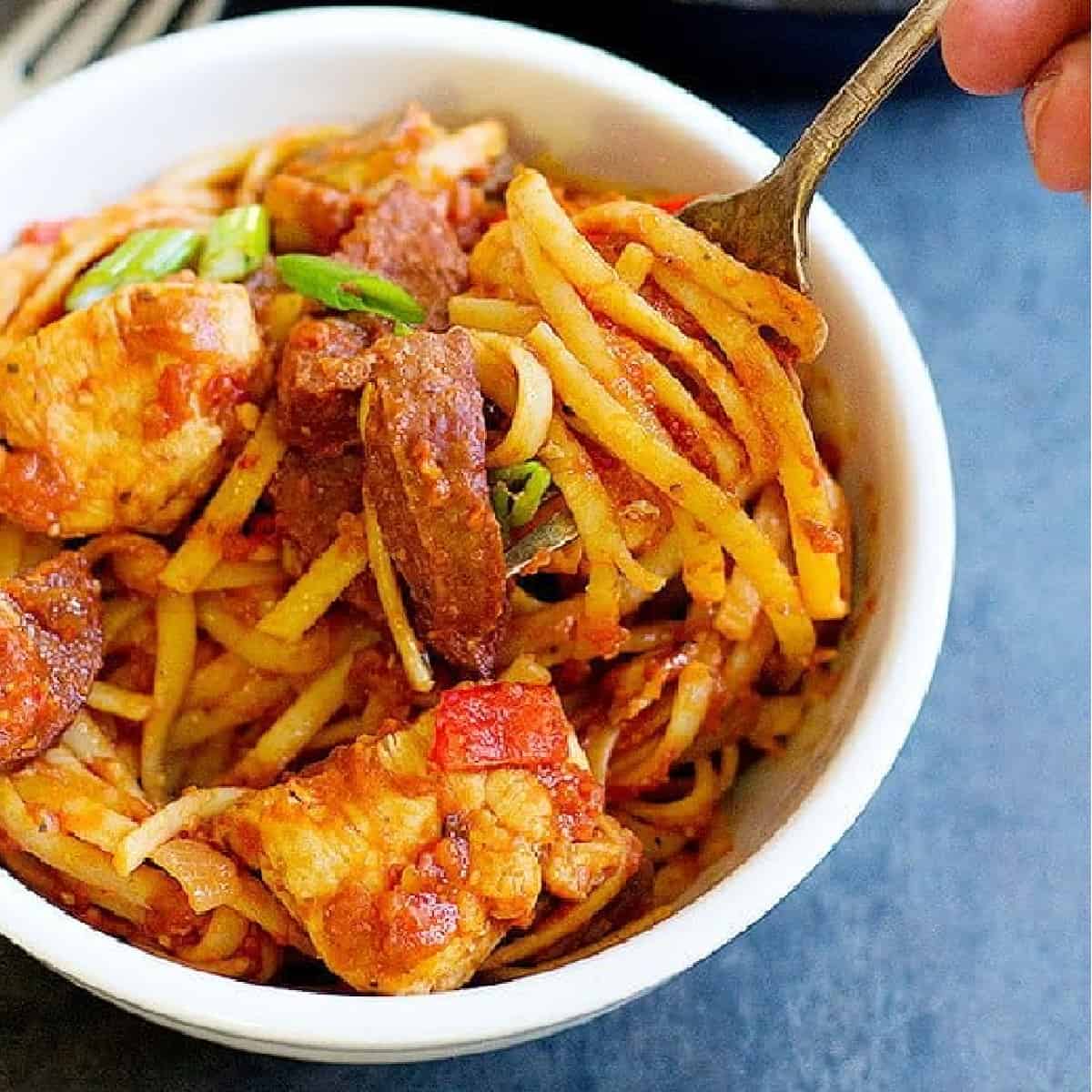 jambalaya pasta in a bowl with a fork. 