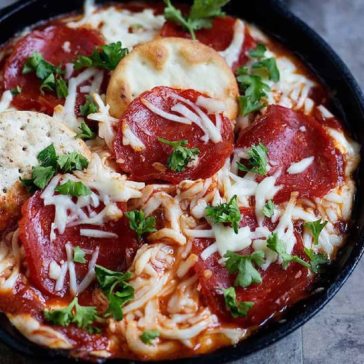 This Pizza Dip is the perfect game day food. Creamy dip topped with pepperoni has tons of flavor in every bite and is a great choice for parties and gatherings!

