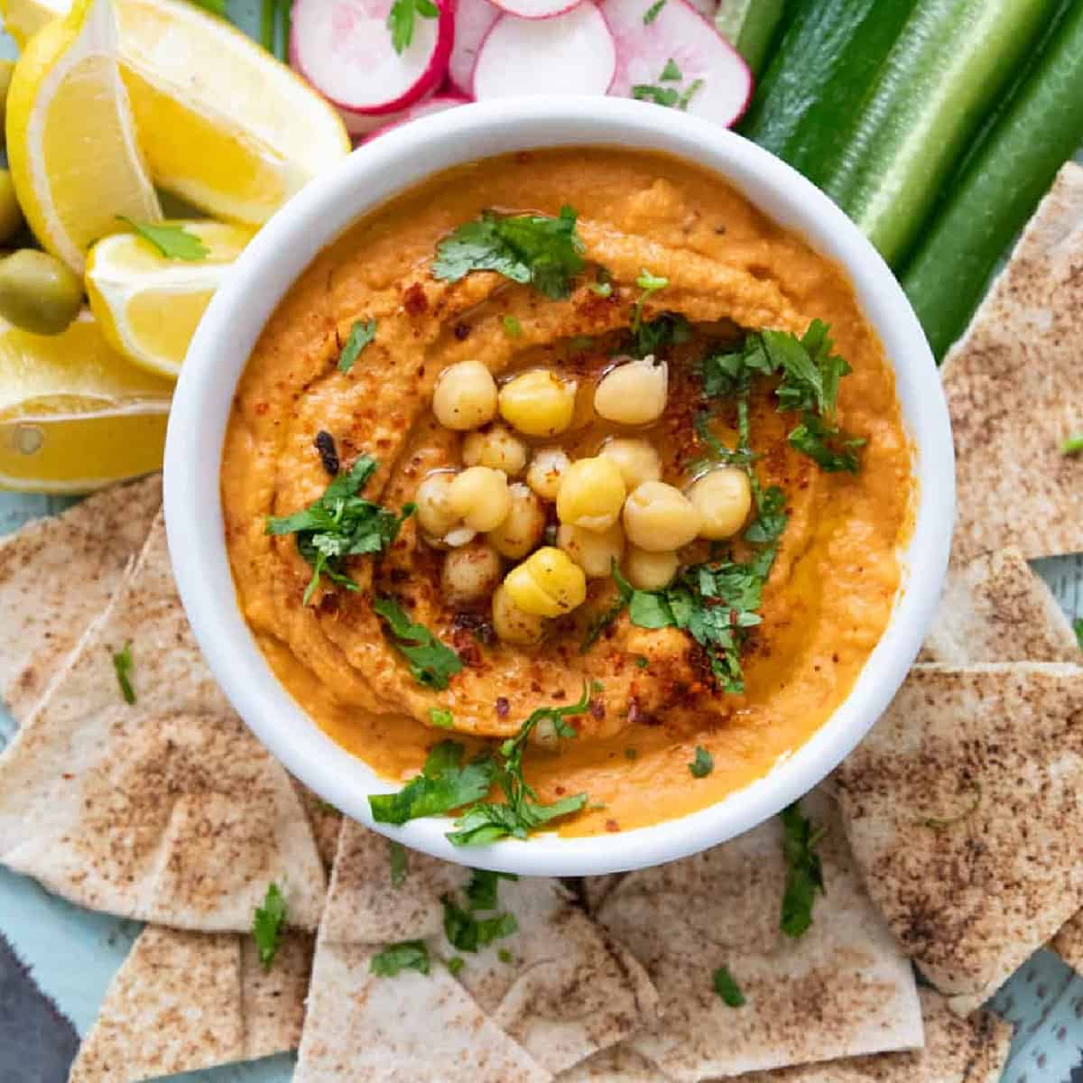 Roasted red pepper hummus is easy and has a nice flavor. The sweetness of roasted red peppers combined with tahini, chickpeas and lemon juice makes a tasty hummus that's perfect for a mezze spread.
