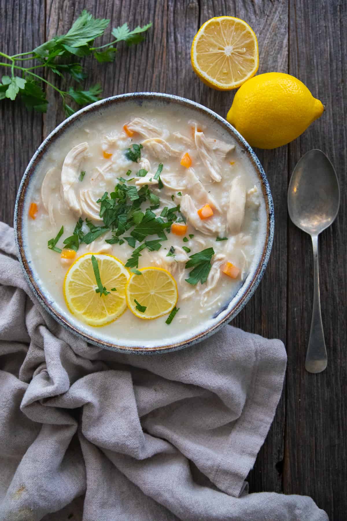 avgolemono with parsley and lemon slices on top.