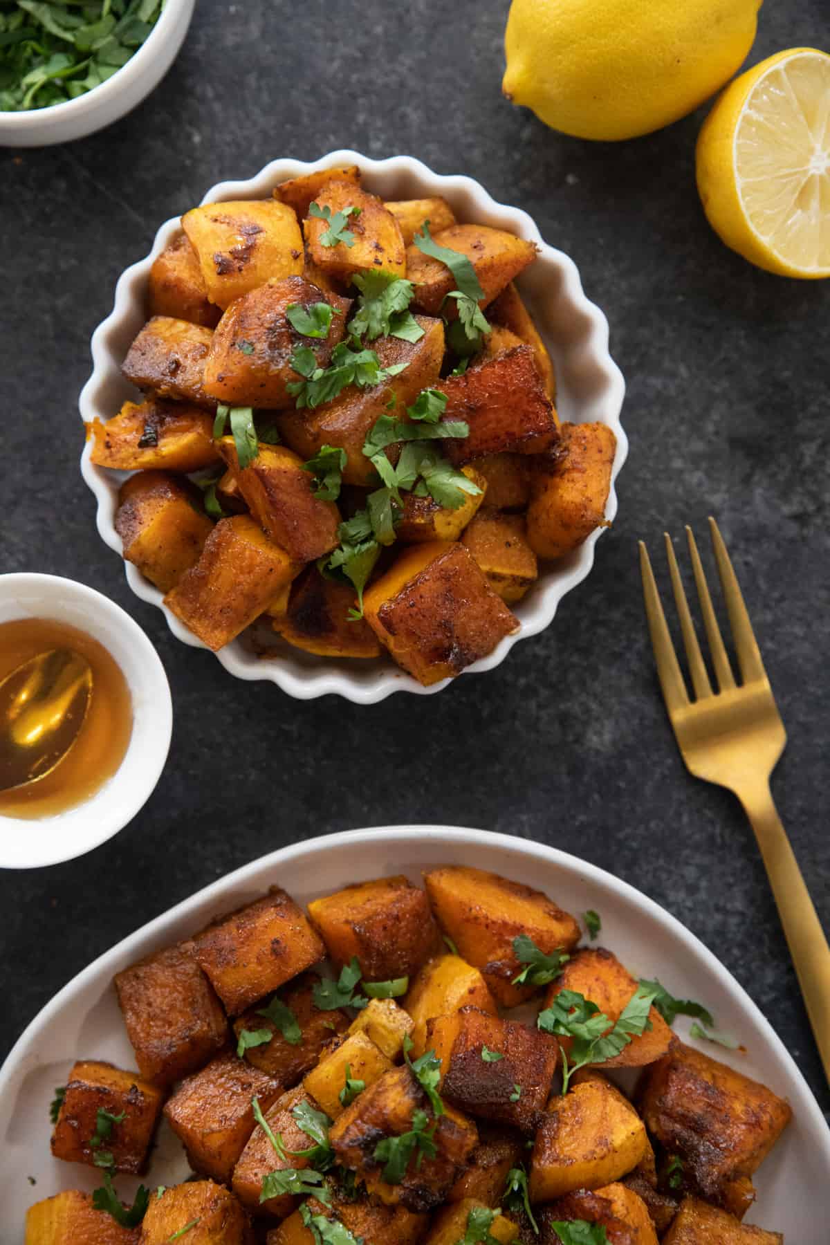 two plates of roasted cubed butternut squash.
