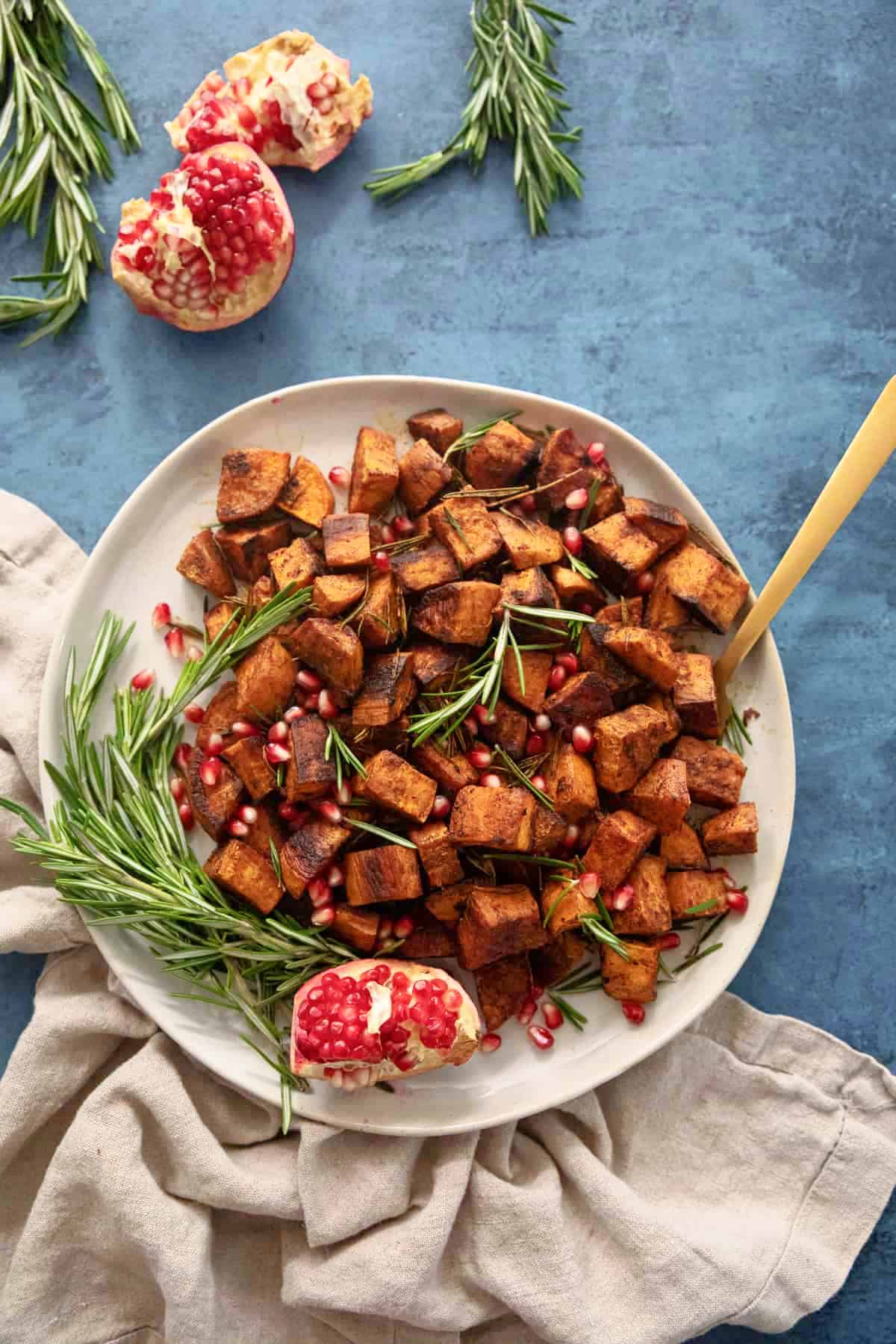 Seasoned Roasted Sweet Potatoes cubes of sweet potatoes roasted to perfection until caramelized served with rosemary and pomegranate