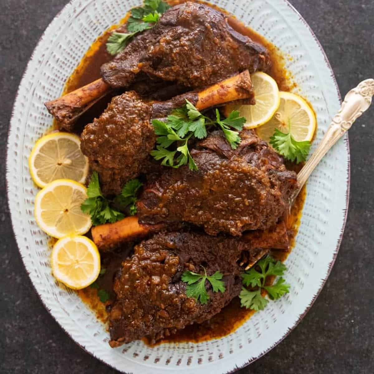 Try the best braised lamb shank recipe ever written! Lamb shanks are slow cooked in a rich spiced sauce until fall-off-the-bone-level fork tender! Serve this restaurant-quality dish with rice, potatoes or even risotto.
