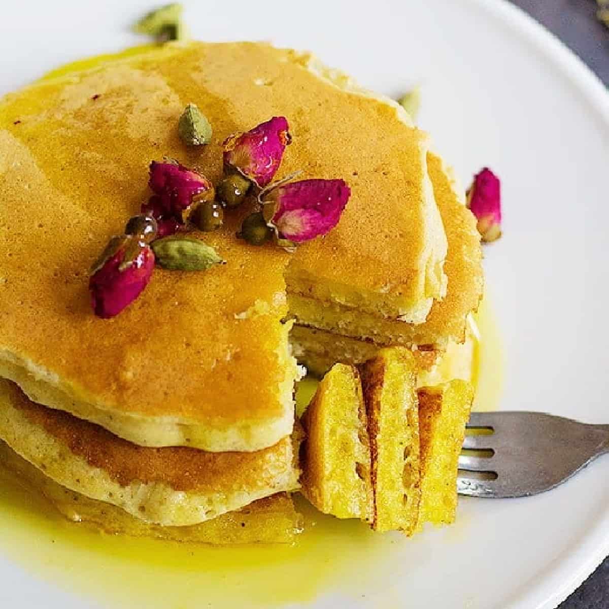 A classic American recipe with a Persian twist, these rosewater cardamom pancakes with saffron syrup are the love between east and west. The fluffy pancakes with rose and cardamom aroma kissed by saffron syrup, a dream come true! 
