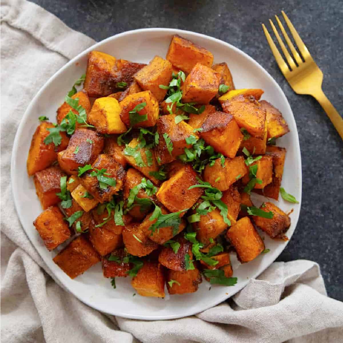 Roasted butternut squash makes an elegant side dish for any occasion. Butternut squash cubes are tossed with olive oil and warm spices and roasted until caramelized, then topped with honey, lemon and cilantro.