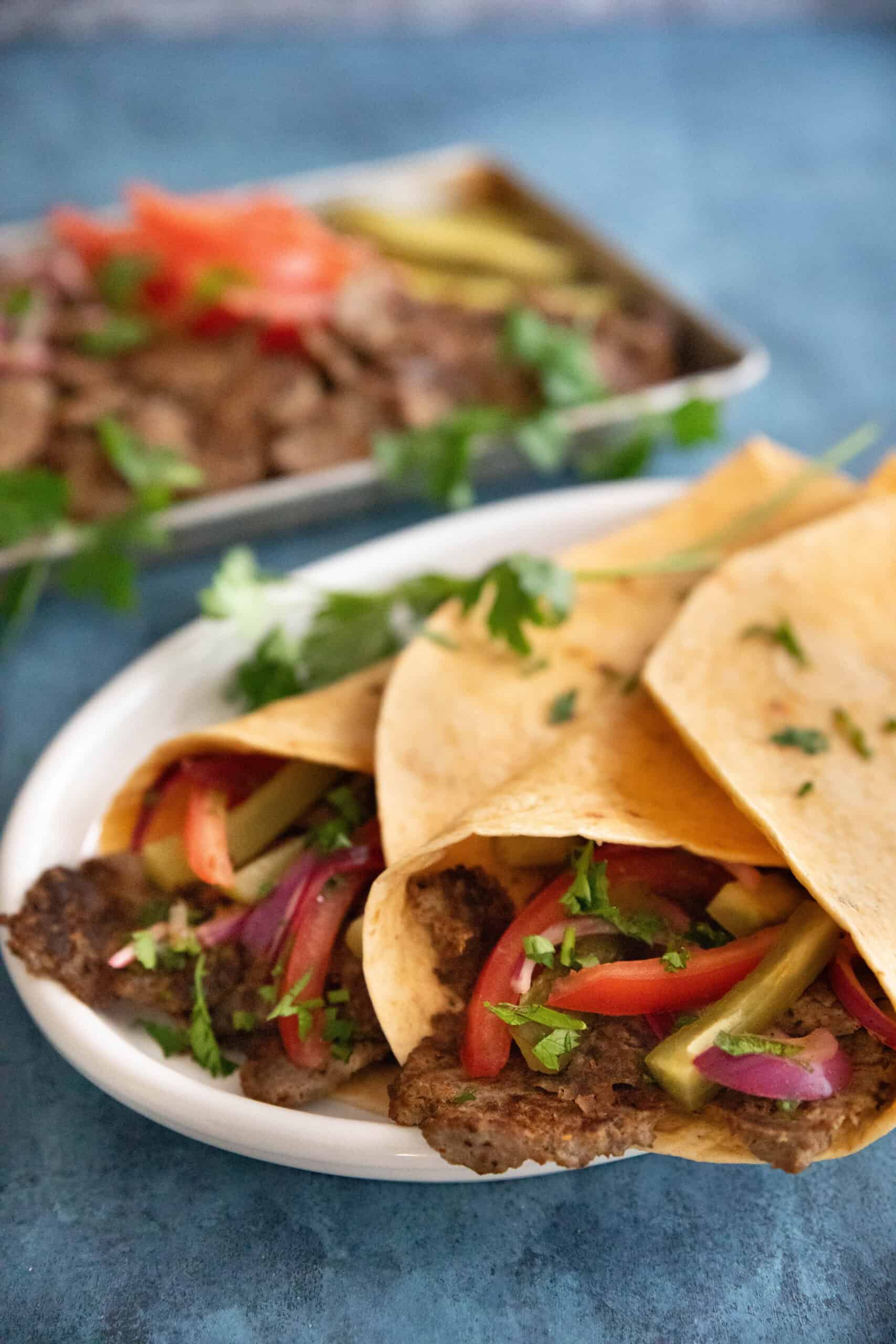 Front shot of doner kebab durum on a platter. 