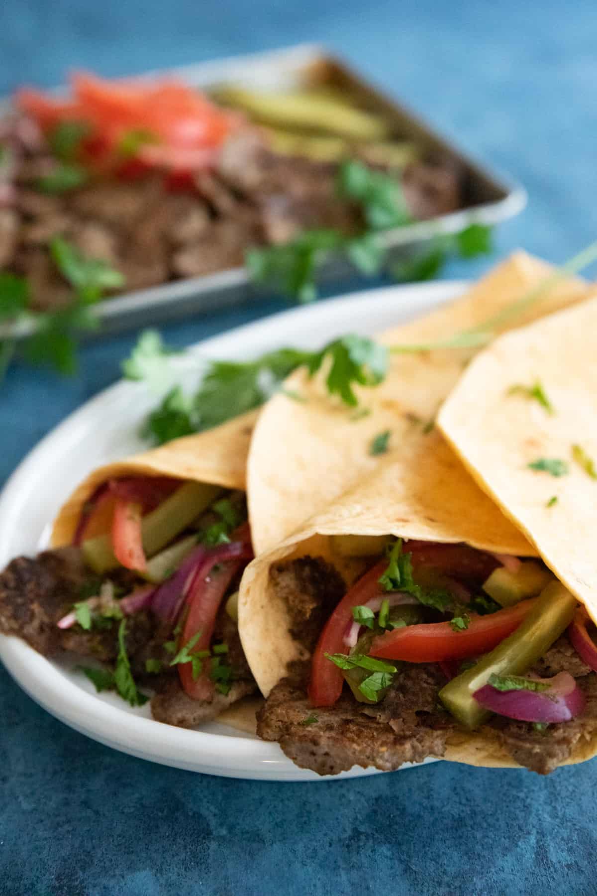 Front shot of doner kebab durum on a platter.