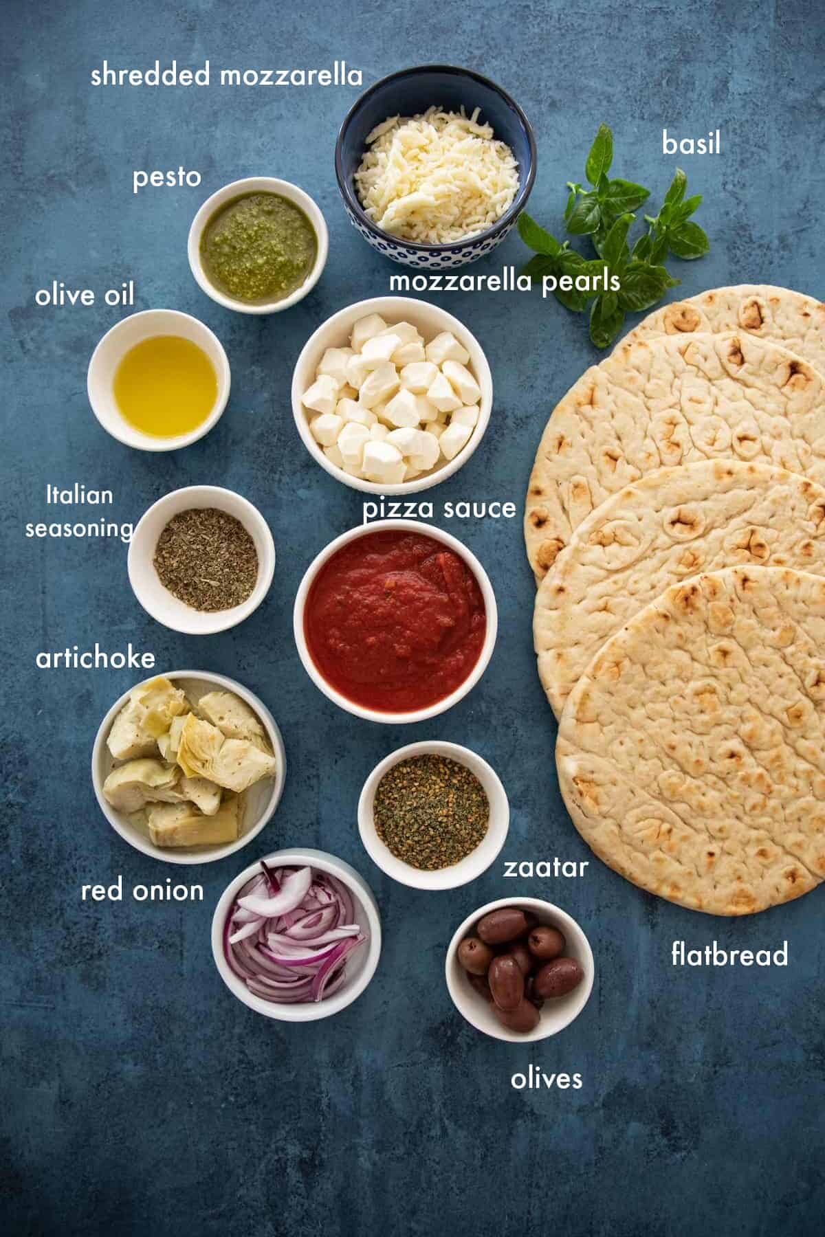 Flatbread pizza toppings including pizza sauce, cheese, vegetables or pesto. 