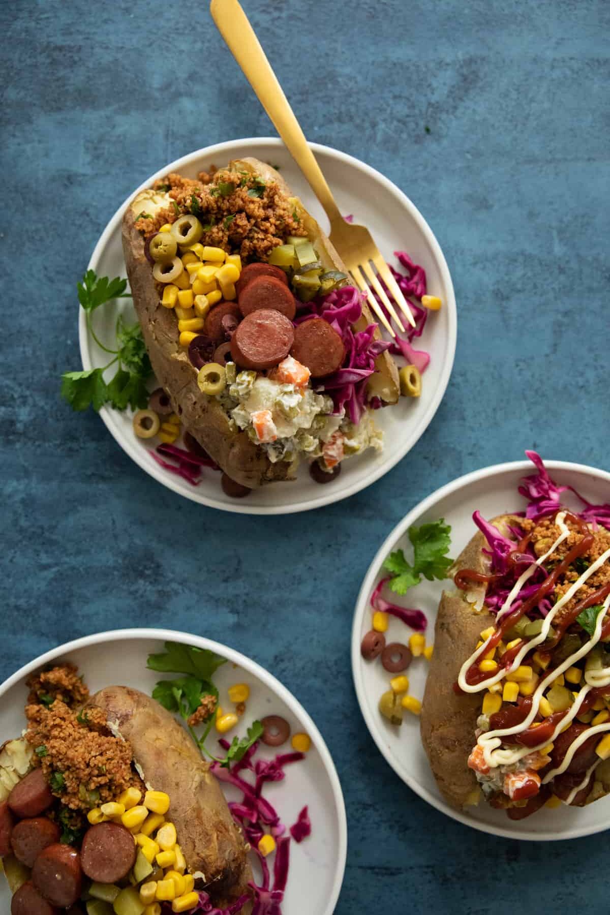 three stuffed baked potatoes known as kumpir. This is a Turkish recipe.