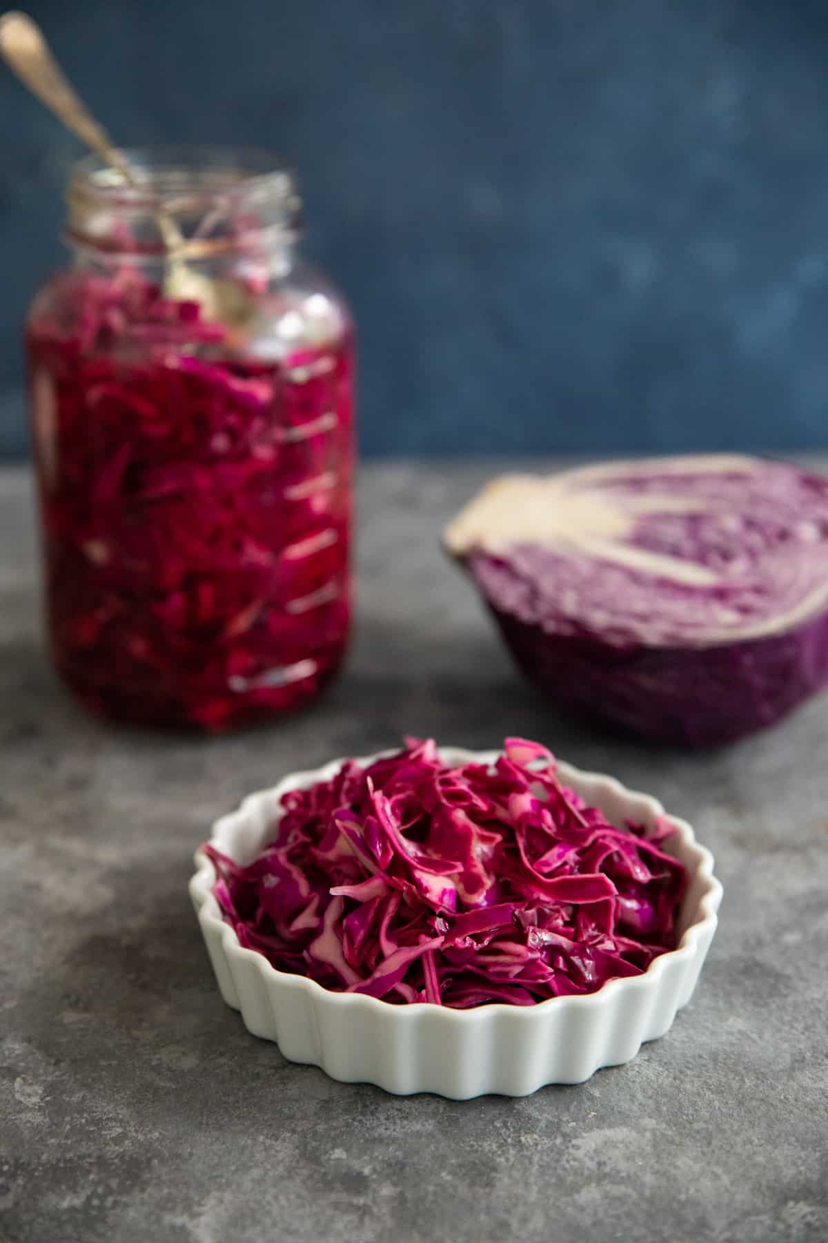 pickled cabbage in a bowl with the jar in the back.