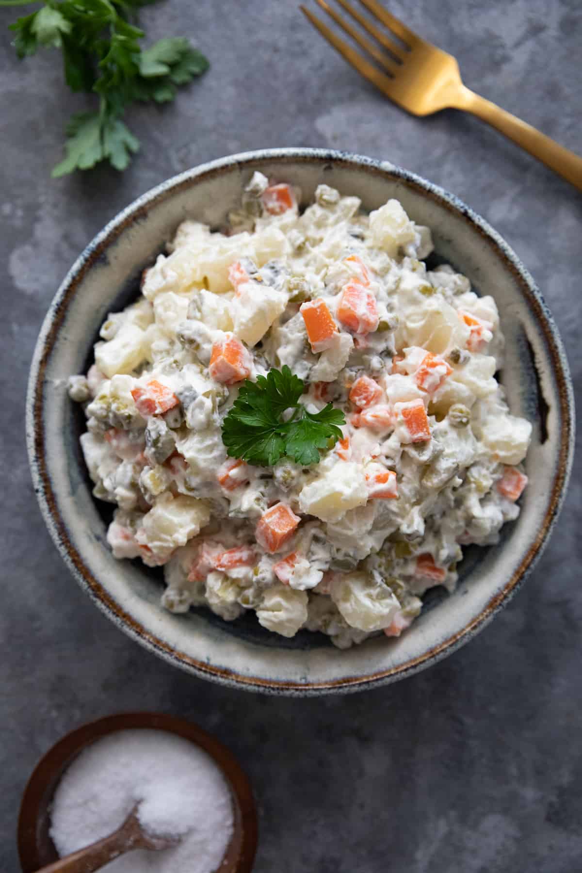 overhead shot of Russian salad on a grey background.