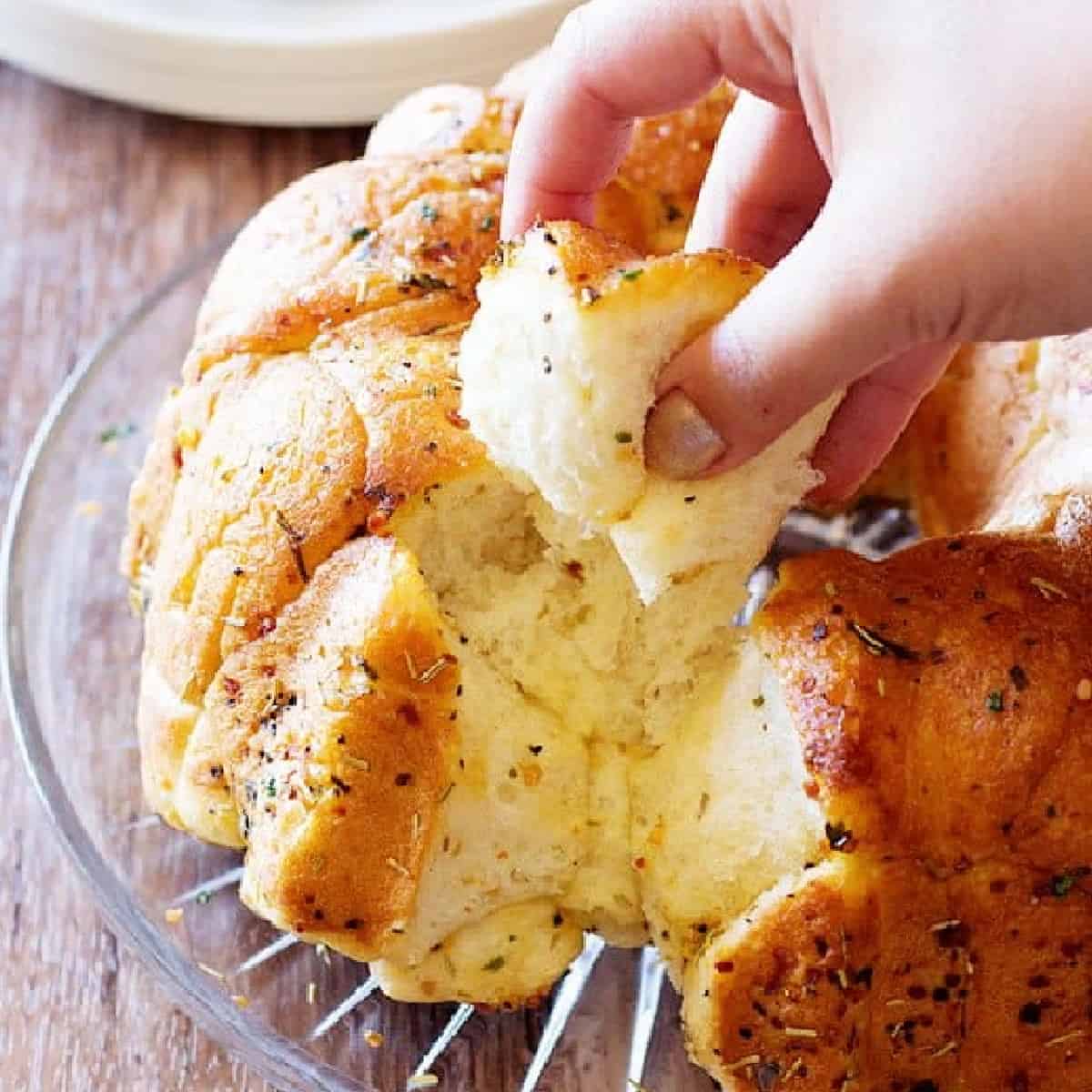 This cheesy rosemary garlic monkey bread is so easy to make, you will want to make it everyday. Buttery garlic monkey bread is the best party food! 
