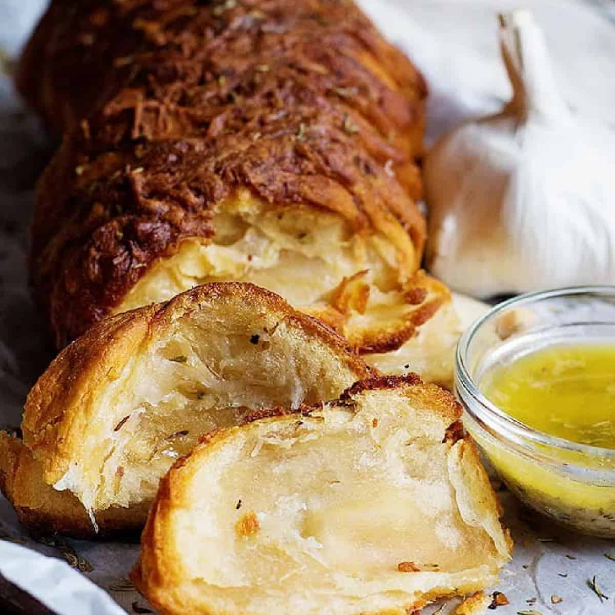 Easy Garlic Cheese Pull Apart Bread is a great appetizer or side and can be made in minutes. Adding lots of garlic and cheese make this bread so delicious. There's no way one bite would be enough!
