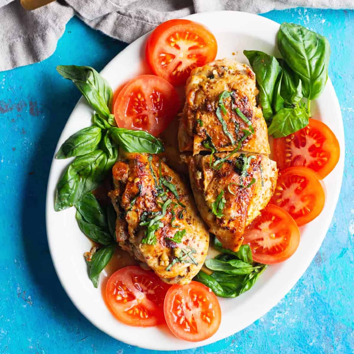 Caprese stuffed chicken breast is easy and packed with flavor. Juicy chicken breast stuffed with cheese, tomatoes and basil makes a delicious meal.