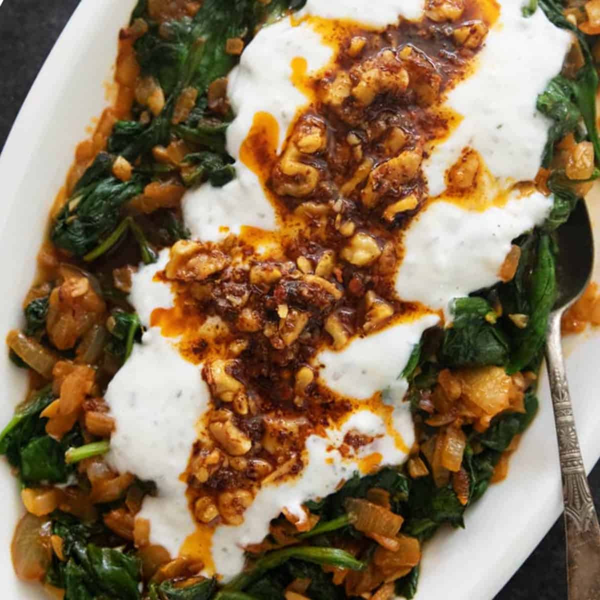 sauteed spinach Turkish style topped with yogurt and Aleppo pepper.