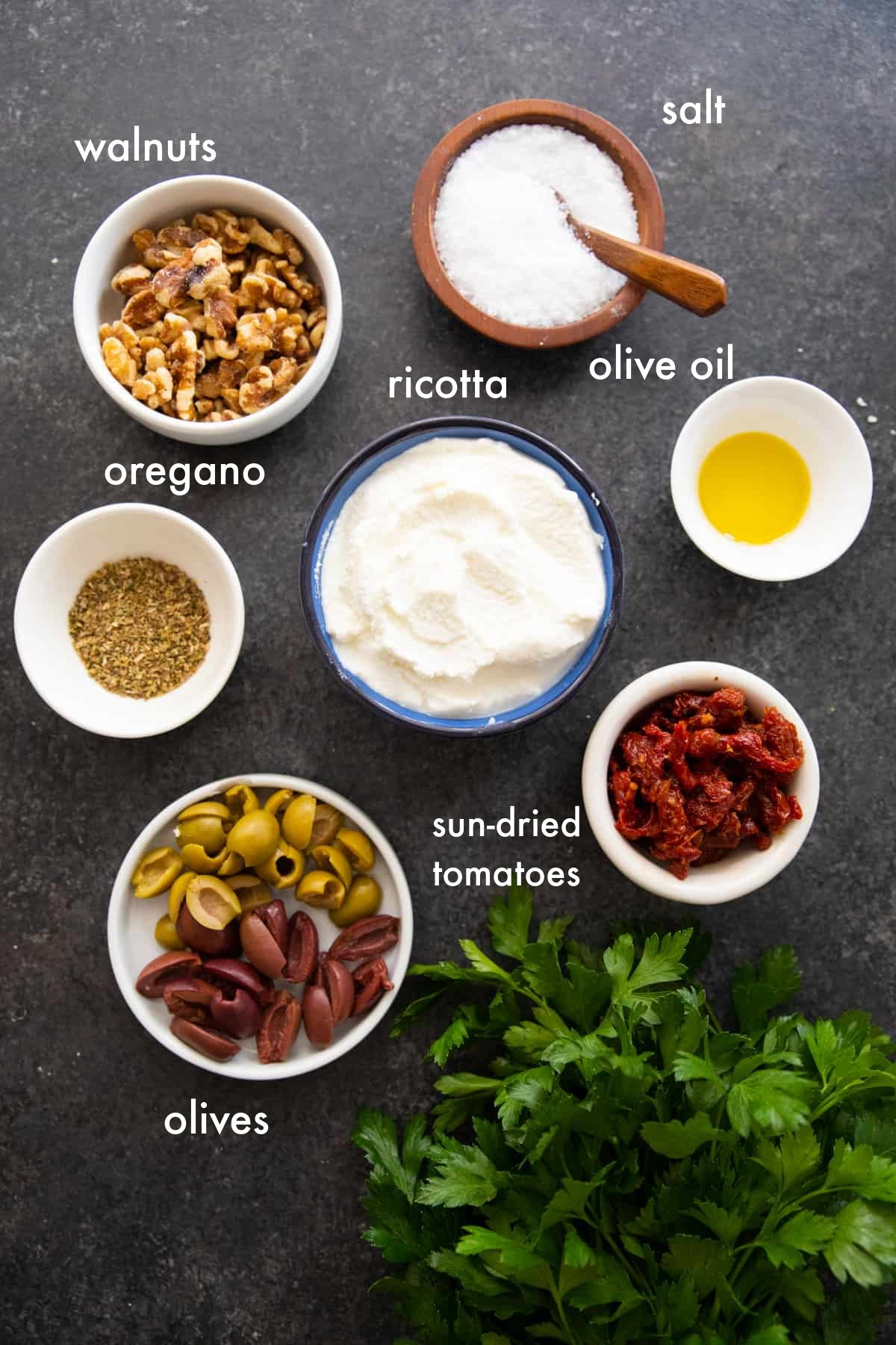 You need ricotta, olive oil, spices, olives, walnuts and sun dried tomatoes to make whipped ricotta. 