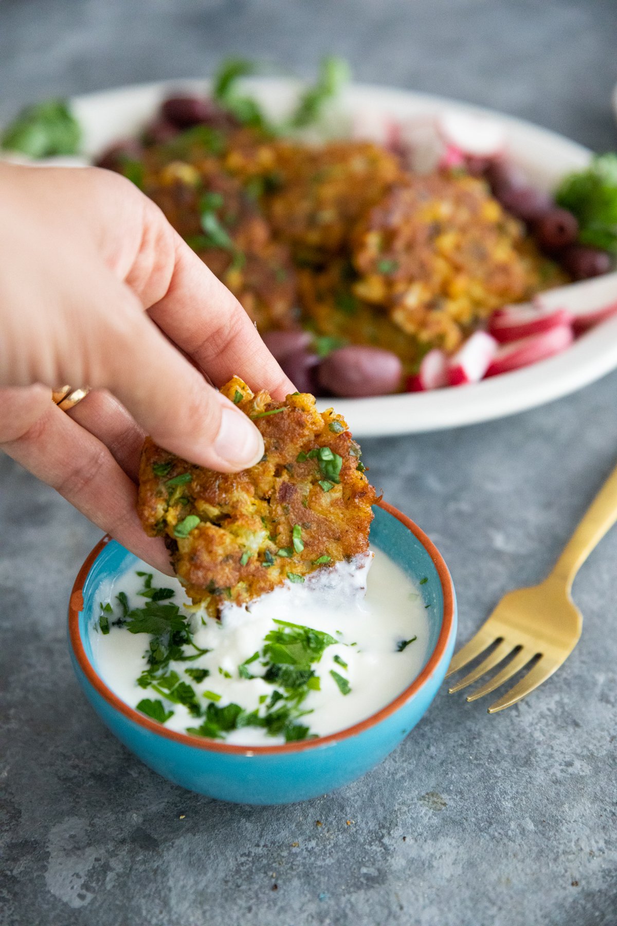 cauliflower fritters dipped into yogurt. 