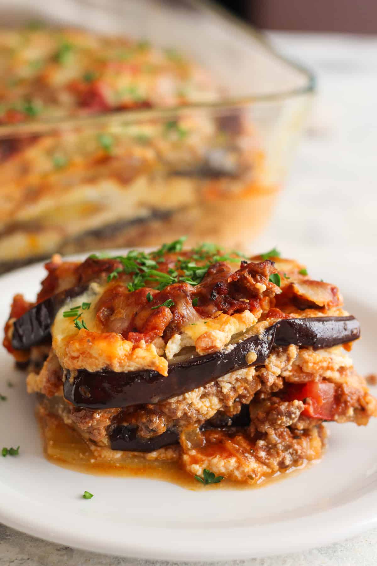 This eggplant lasagna is absolutely cheesy and rich in flavor with layers of eggplant, delicious meat sauce and 3 kinds of cheese! It's made without any noodles, so it's gluten free and low carb. This is a great recipe to use up those eggplants sitting in the fridge. Watch the video to see how to make this recipe, vegetarian option also included!