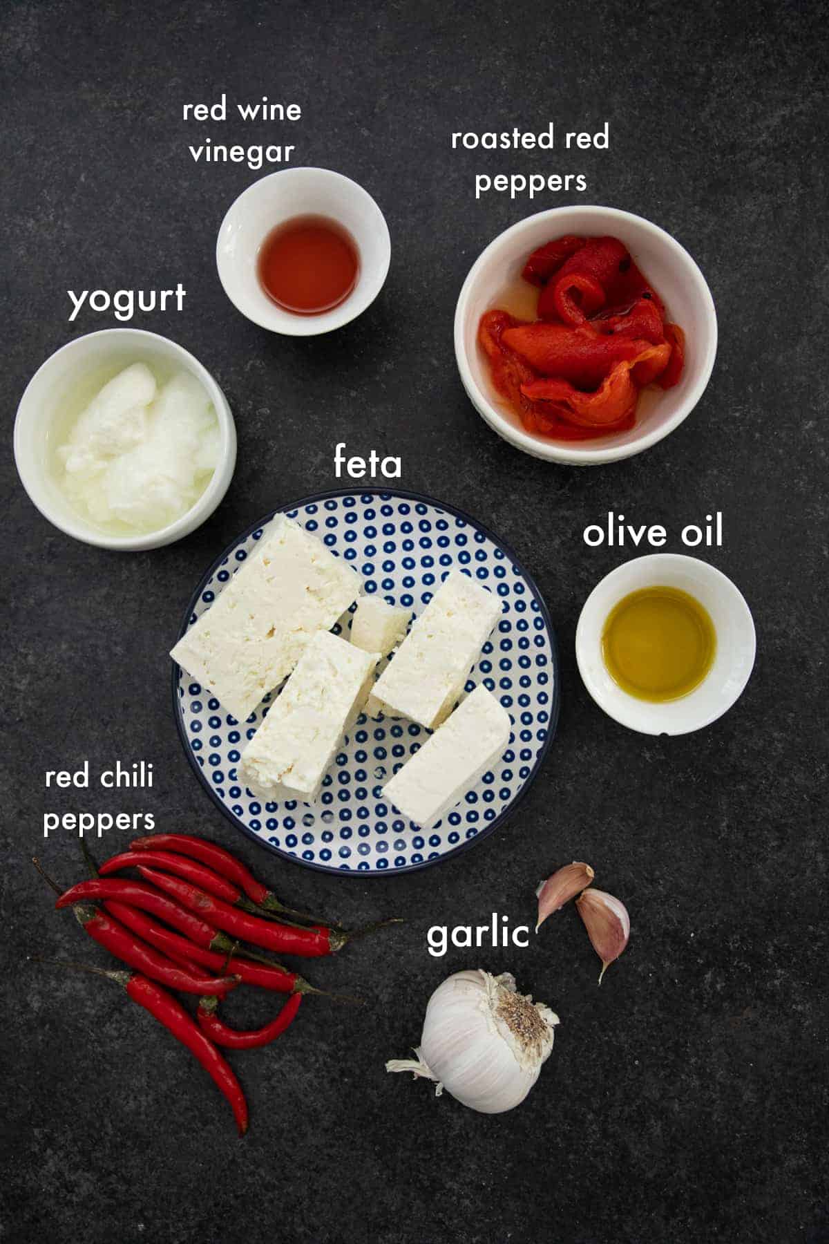 you need feta, chili pepepr, roasted red pepper, olive oil, garlic and yogurt to make spicy Greek feta dip. 
