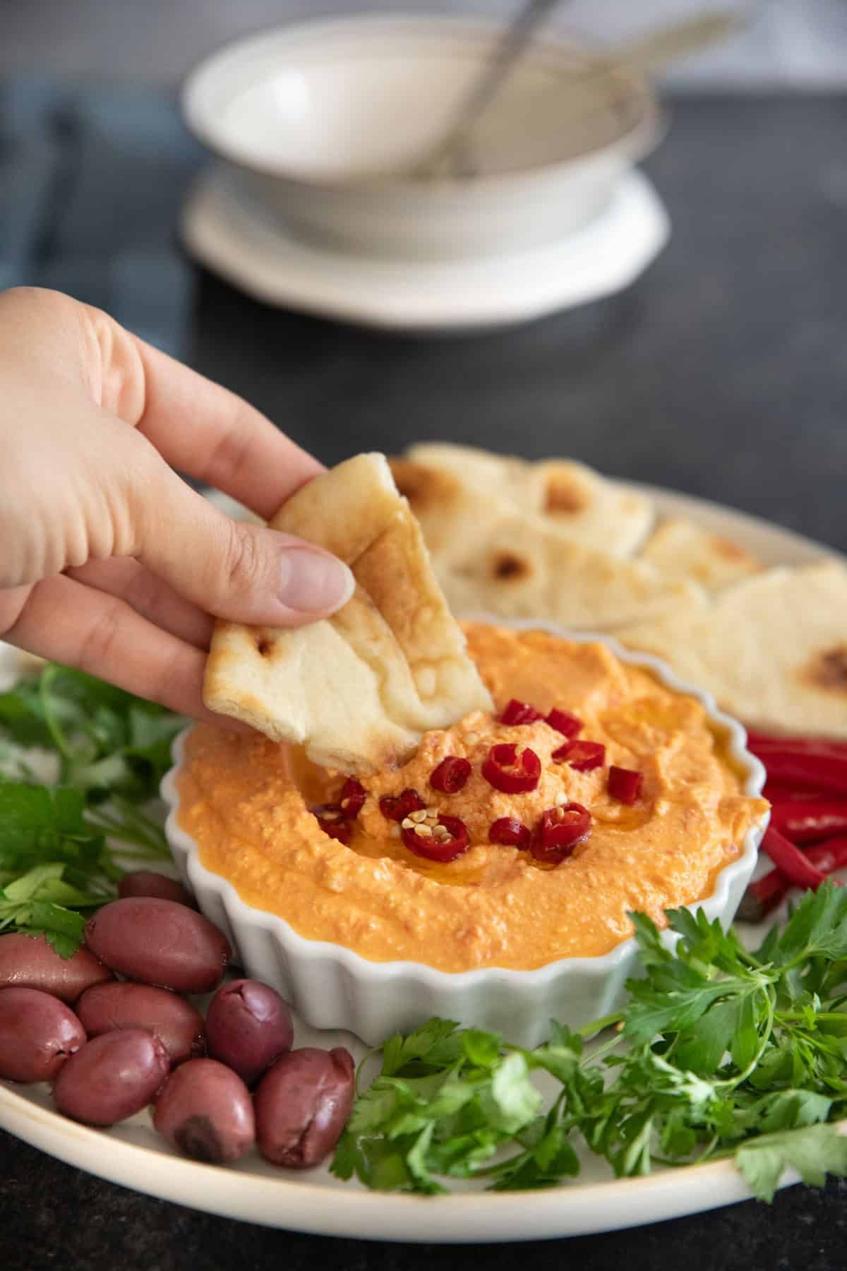 Dip pita bread in tirokafteri.