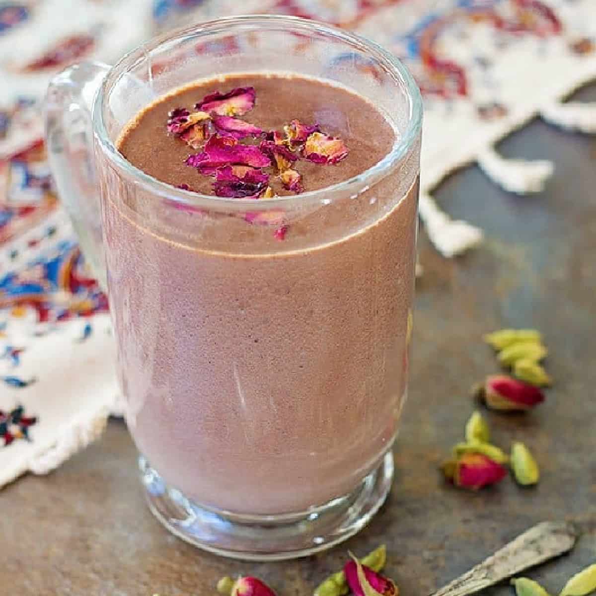 Rich Cardamom Rose Hot Chocolate is a delicious cozy drink for cold winter evenings. Quality chocolate melted in milk and infused with Middle Eastern ingredients makes for a dreamy drink.
