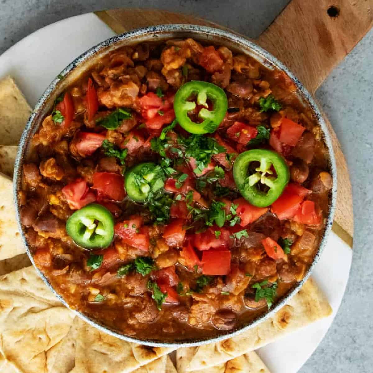 ful medames topped with tomatoes and herbs.